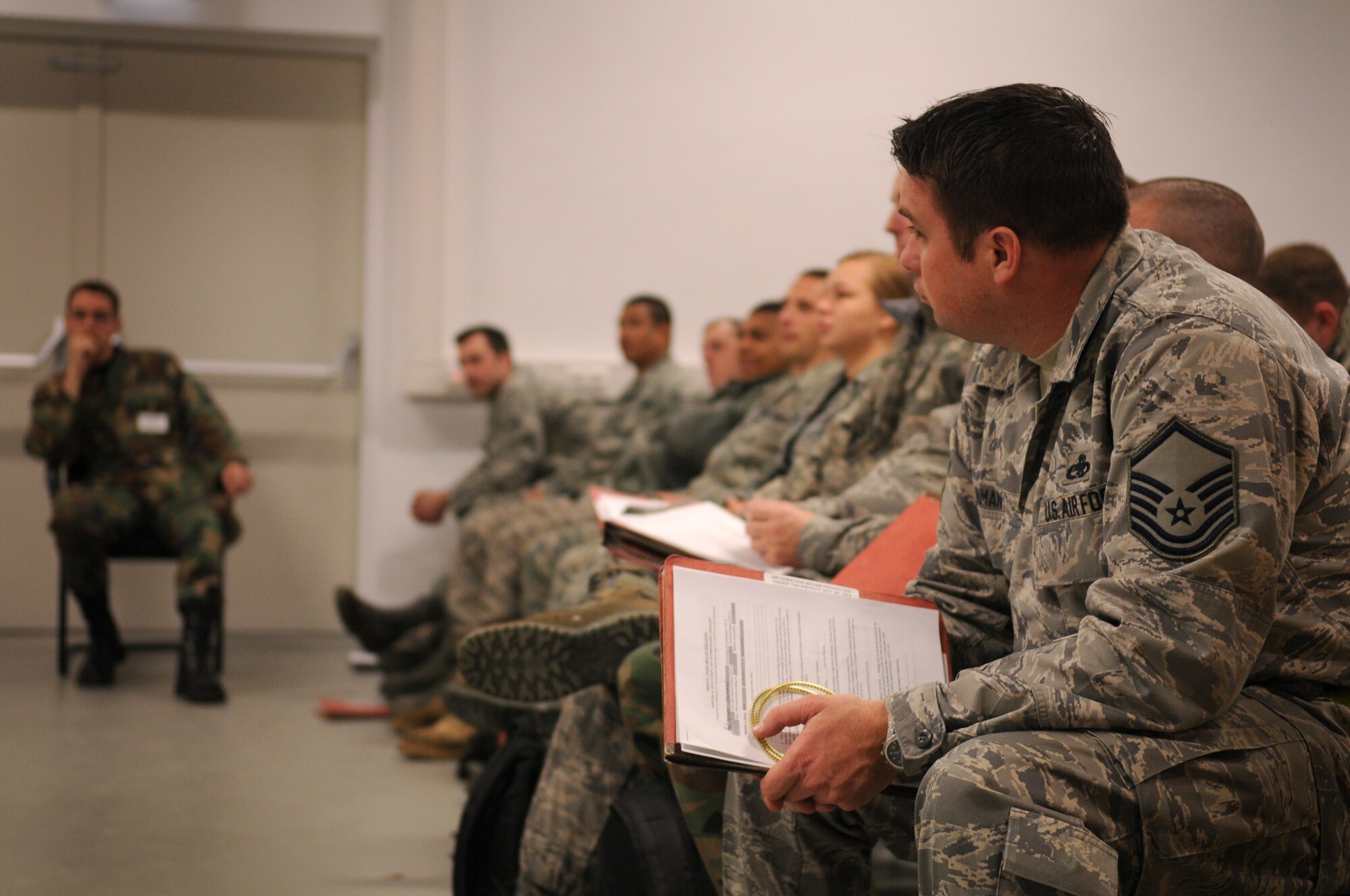 SPANGDAHLEM AIR BASE, Germany -- Master Sgt. James Inman, 52nd Aircraft Maintenance Squadron, listens to briefers during a personnel deployment function here Nov. 19. The 52nd Fighter Wing conducted a Phase I exercise to prepare for a NATO tactical evaluation scheduled for June 2010. (U.S. Air Force photo/Airman 1st Class Nathanael Callon)