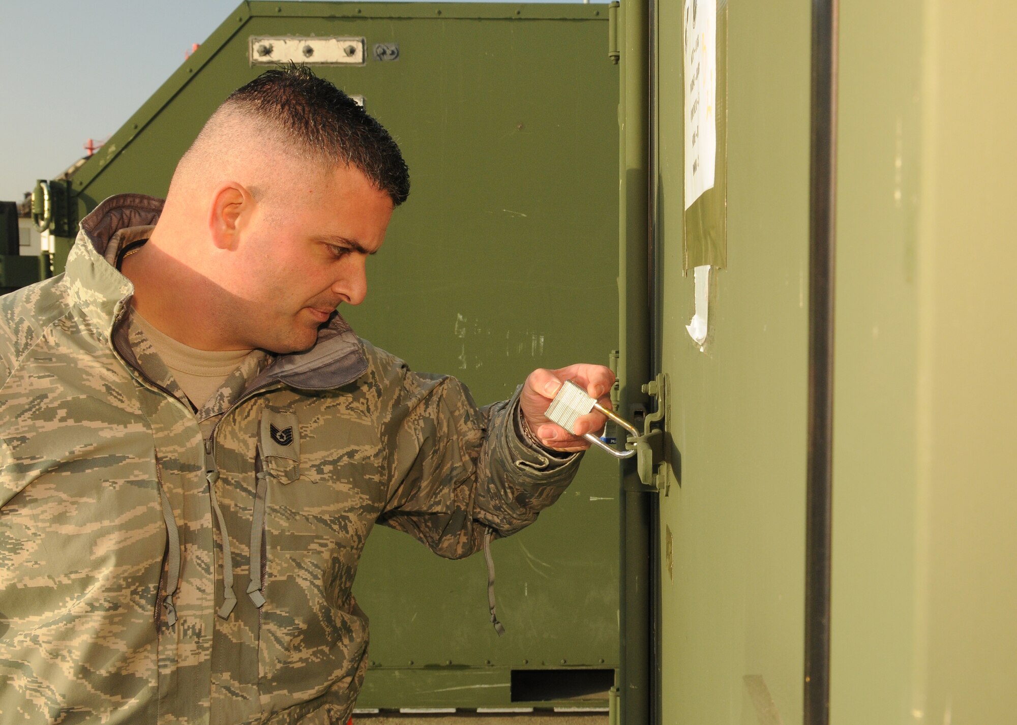 SPANGDAHLEM AIR BASE, Germany -- Tech. Sgt. Dominick Delango, 726th Air Mobility Squadron, opens a lock on a piece of freight Nov. 20 here. The 52nd Fighter Wing simulated the deployment of personnel and assets to a forward-operating base during Operation Saber Crown 10-02. (U.S. Air Force photo/Airman 1st Class Nathanael Callon)