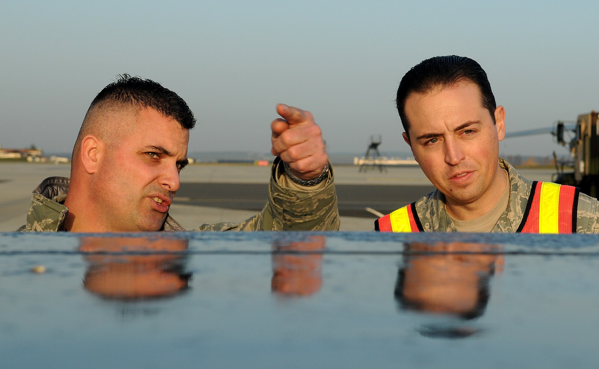SPANGDAHLEM AIR BASE, Germany -- Tech. Sgt. Dominick Delango, 726th Air Mobility Squadron, explains a method of inspecting cargo for shipment to Master Sgt. Jason Klug, 52nd Logistics Readiness Squadron, during a joint inspection of freight Nov. 20 here. The 52nd Fighter Wing evaluated its ability to respond to a rapid deployment of personnel and assets during Operation Saber Crown 10-02. (U.S. Air Force photo/Airman 1st Class Nathanael Callon)