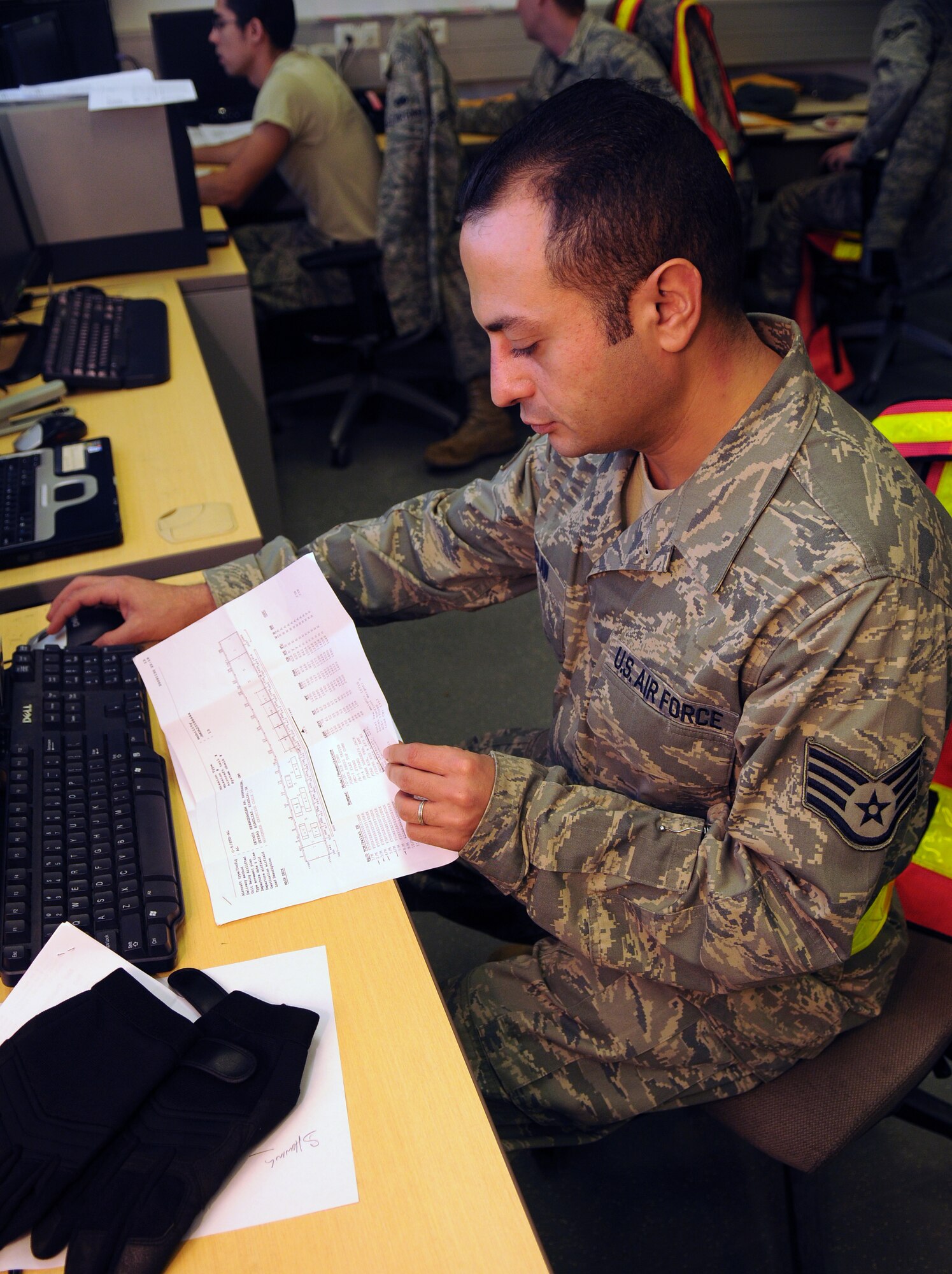 SPANGDAHLEM AIR BASE, Germany -- Staff Sgt. Nasser McLaw, 52nd Logistics Readiness Squadron, reviews a shipping manifest during the Phase I exercise Nov. 20 in the cargo deployment function control center here. The 52nd Fighter Wing simulated the deployment of personnel and assets to a forward-operating base during Operation Saber Crown 10-02. (U.S. Air Force photo/Airman 1st Class Nathanael Callon)