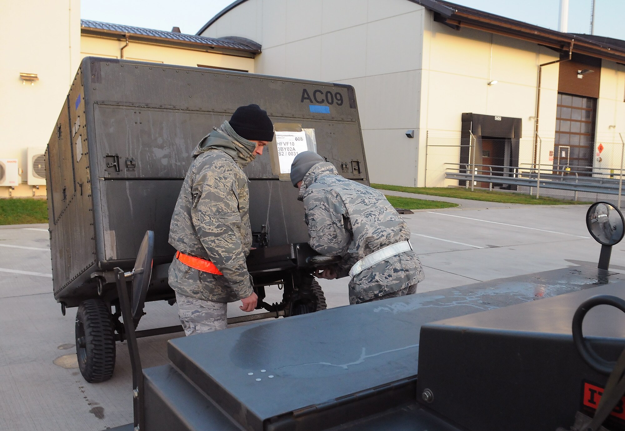 SPANGDAHLEM AIR BASE, Germany -- Tech. Sgts. Michael Southwell and Dustin Wood, 52nd Equipment Maintenance Squadron, prepare a piece of equipment for transport during the Phase I exercise Nov. 20 here. The 52nd Fighter Wing evaluated its ability to respond to a threat and deploy personnel, equipment and assets to a forward-operating base within a short period of time. (U.S. Air Force photo/Airman 1st Class Nathanael Callon)