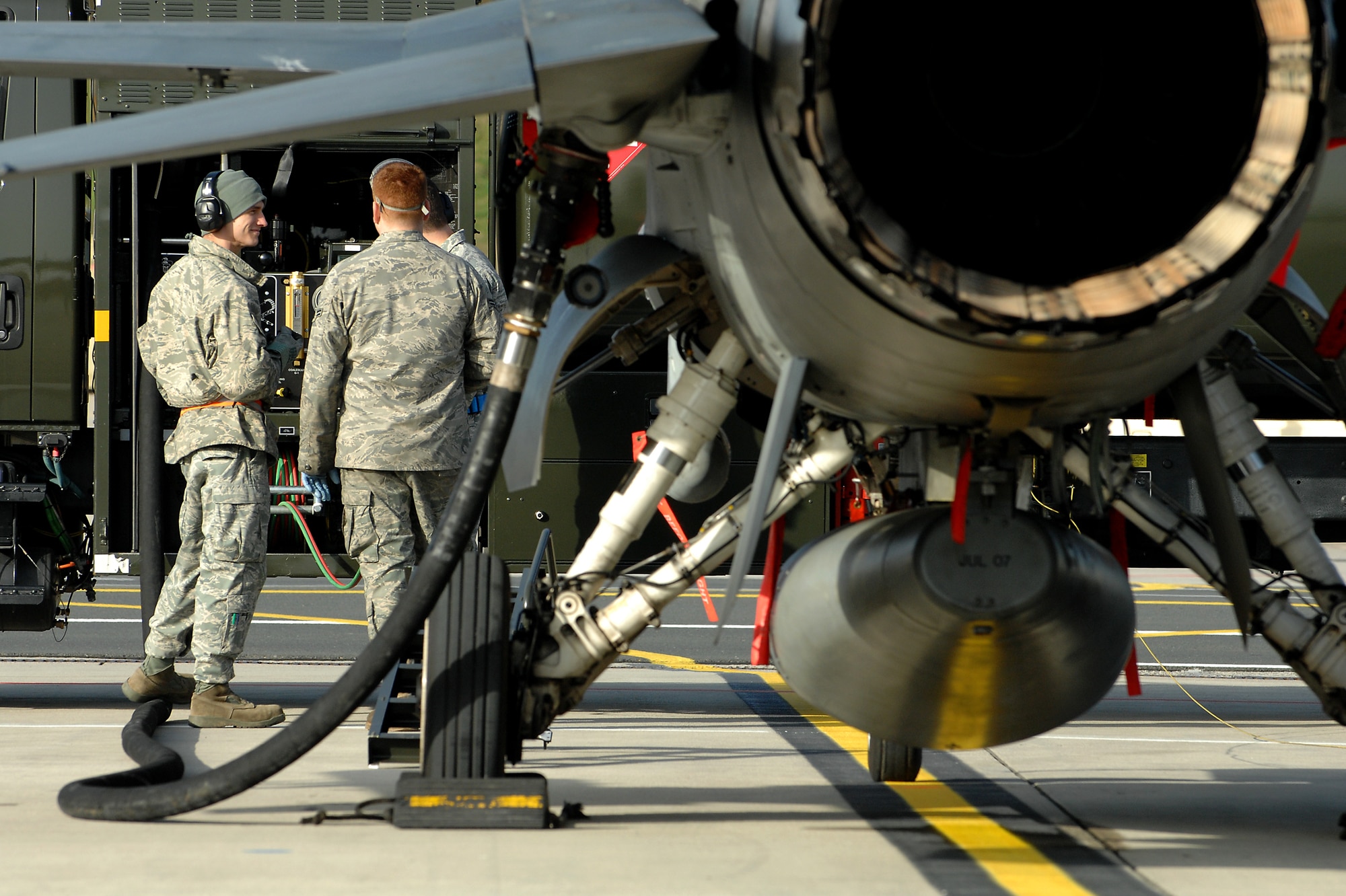 SPANGDAHLEM AIR BASE, Germany -- Airmen from the 52nd Logistics Readiness Squadron fuel a 22nd Fighter Squadron F-16 Fighting Falcon Nov. 20 here. The 52nd Fighter Wing participated in Operation Saber Crown 10-02 to evaluate the ability to function during a real-world contingency. (U.S. Air Force photo/Airman 1st Class Nathanael Callon)