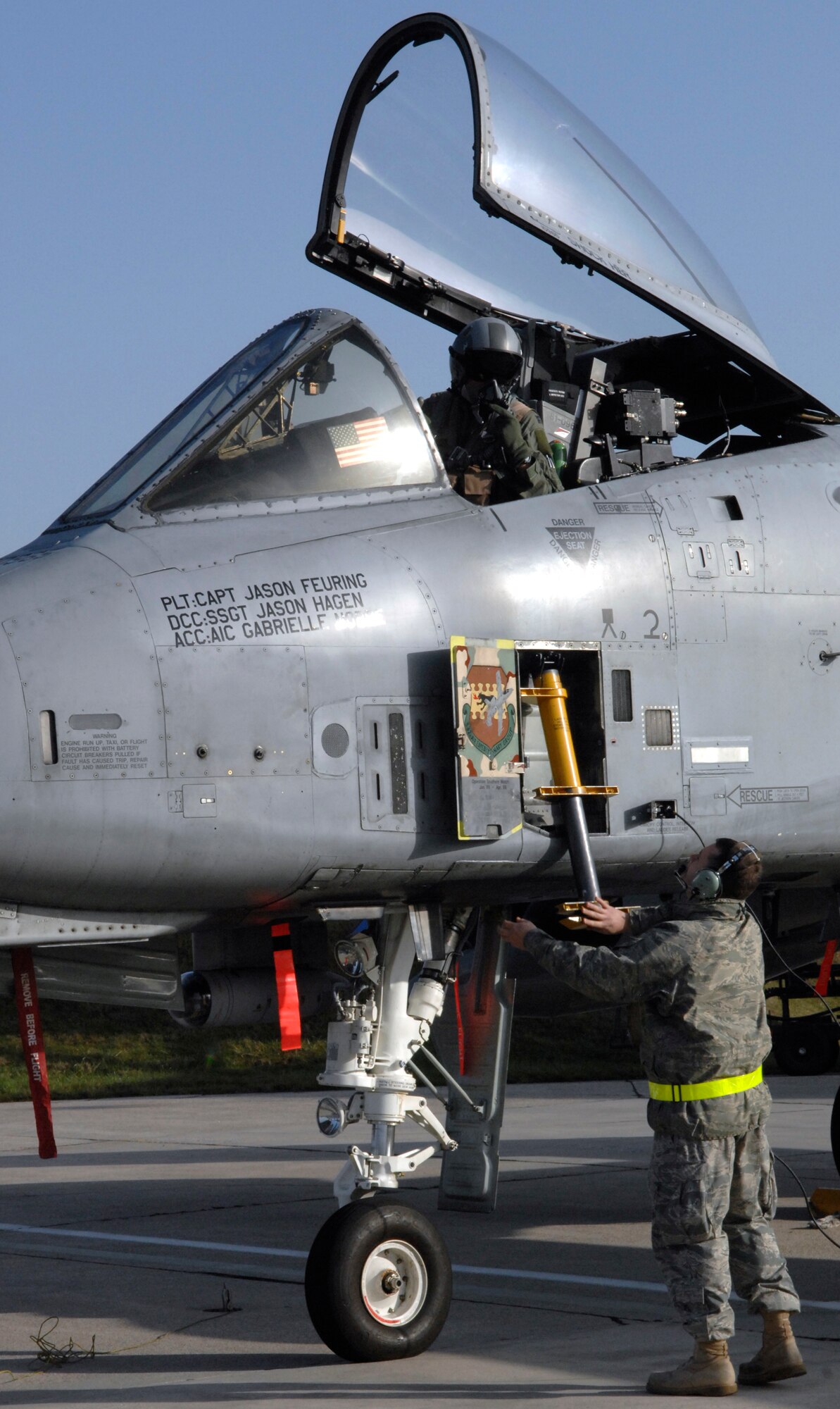 SPANGDHALEM AIR BASE, Germany –Senior Airman Josh Ogles, 52nd Aircraft Maintenance Squadron avionics specialist, releases the ladder of an A-10 Thunderbolt II for Capt. Gary Moore, 52nd Operations Group executive officer and A-10 pilot, during a post-flight inspection here Nov. 20. The A-10 was part of a six-ship flying formation that flew to a simulated deployed location during Operation Saber Crown 10-02. (U.S. Air Force photo/Senior Airman Kali L. Gradishar)