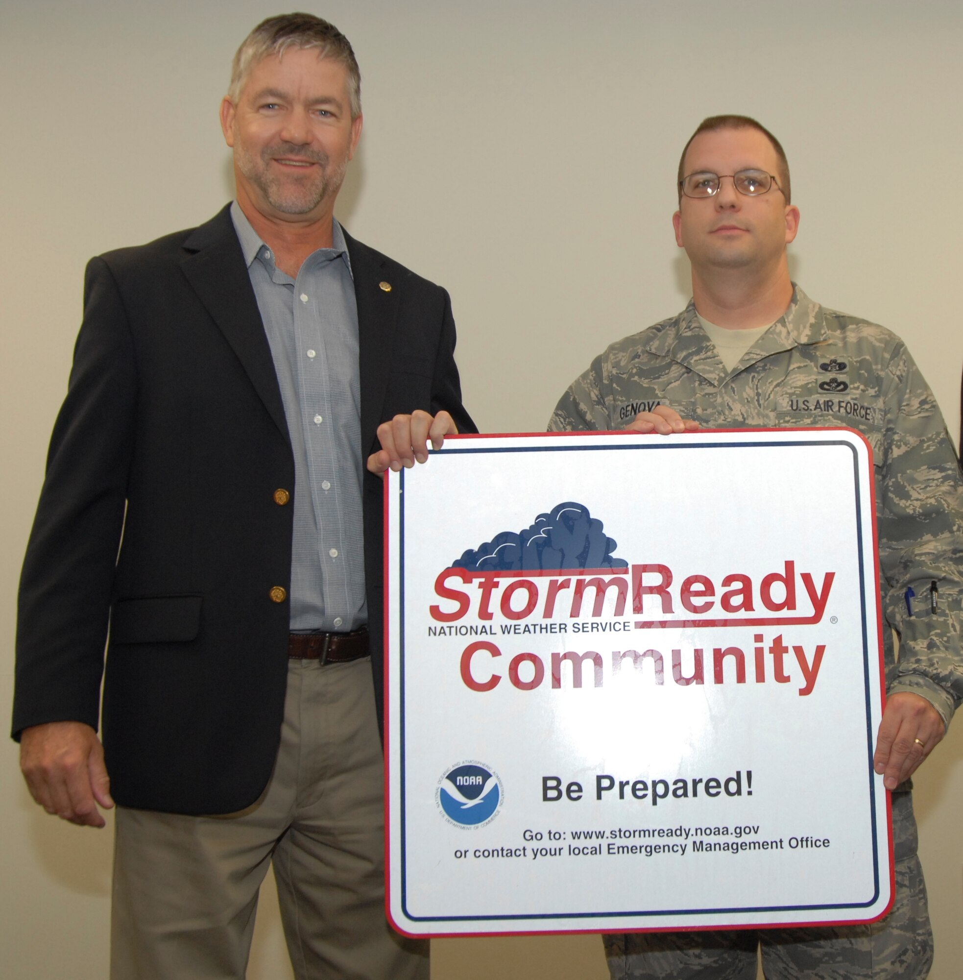 Bob Goree, National Weather Service Warning Coordination Meteorologist, recognizes Team Tyndall as a StormReady community and presents a sign to Master Sgt. Rob Genova, 325th Civil Engineer Squadron Readiness and Emergency Management flight superintendent.  (U.S. Air Force photo/Susan Trahan) 