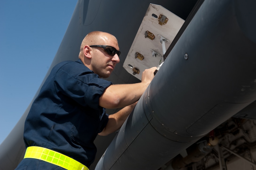 Senior Airman Brad Emerson, 37th Aircraft Maintenance Unit offensive aviation systems technician, checks for proper installation of the Sniper Advanced Targeting Pod on a B-1B Lancer, Nov. 15, in Southwest Asia. The 37 AMU works to keep the B-1 operational and safe for missions in the U.S. Central Command area of responsibility. Airman Emerson is deployed from Ellsworth Air Force Base, S.D. in support of operations Iraqi and Enduring Freedom. (U.S. Air Force photo/Staff Sgt. Robert Barney)