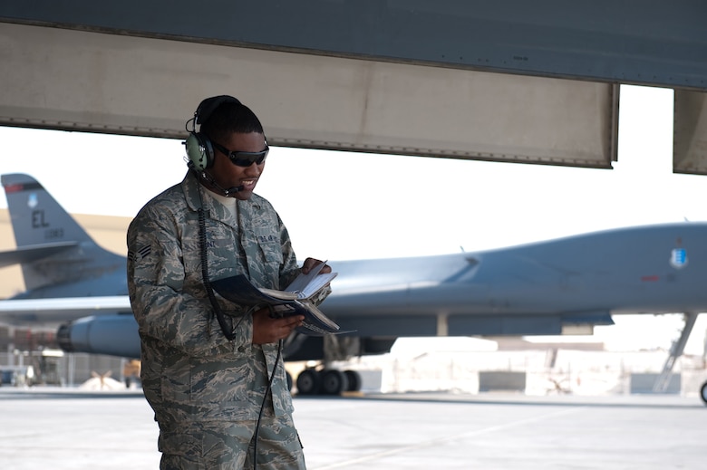 Senior Airman William Hunt, 37th Aircraft Maintenance Unit crew chief, reviews technical orders while refueling a B-1B Lancer, Nov. 15, in Southwest Asia. The 37 AMU works to keep the B-1 operational and safe for missions in the U.S. Central Command area of responsibility. Airman Hunt is deployed from Ellsworth Air Force Base, S.D. in support of operations Iraqi and Enduring Freedom. (U.S. Air Force photo/Staff Sgt. Robert Barney)