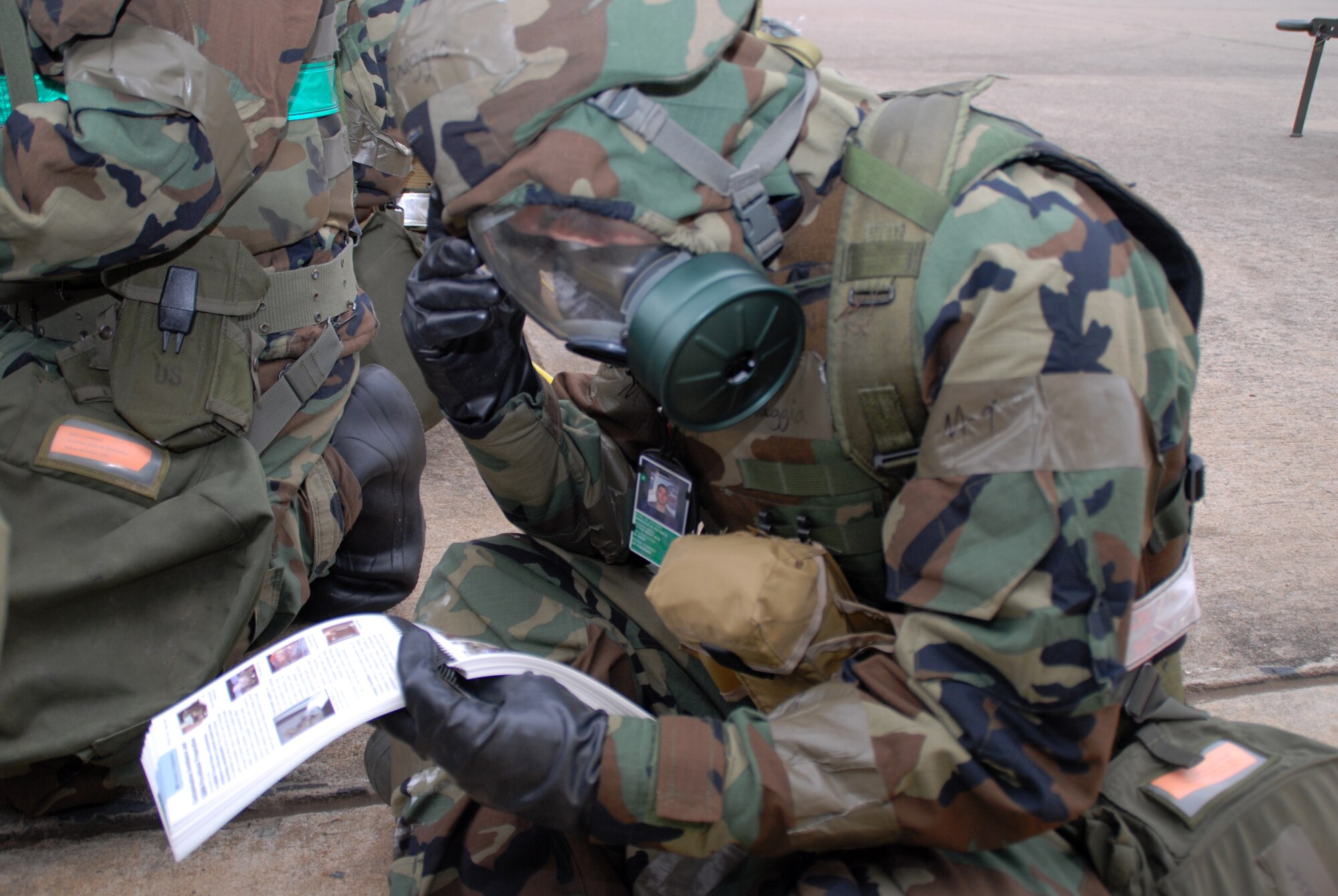 Tech. Sgt. Peter Dimaggio III, 19th Aircraft Maintenance Squadron electrical environmental journeyman, takes time to study his Airman’s Manual while waiting for the building to be cleared after being attacked during a base exercise Nov. 17. (U.S. Air Force photo by Senior Airman Michael Watkins)