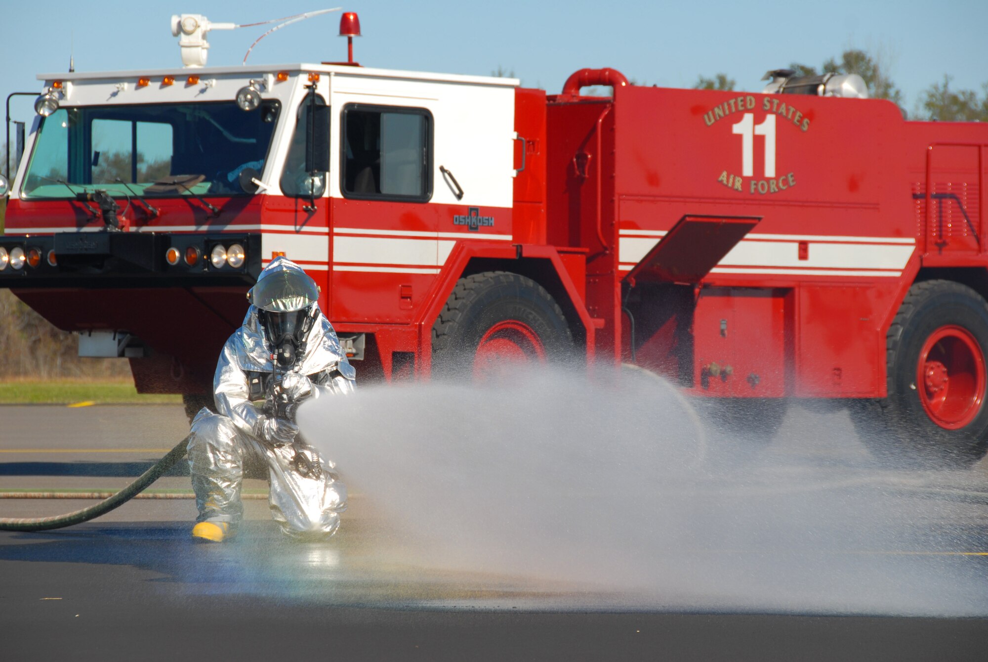 A Maxwell firefighter hoses down the runway at the Prattville airport. (U.S. Air Force photo/Jamie Pitcher)