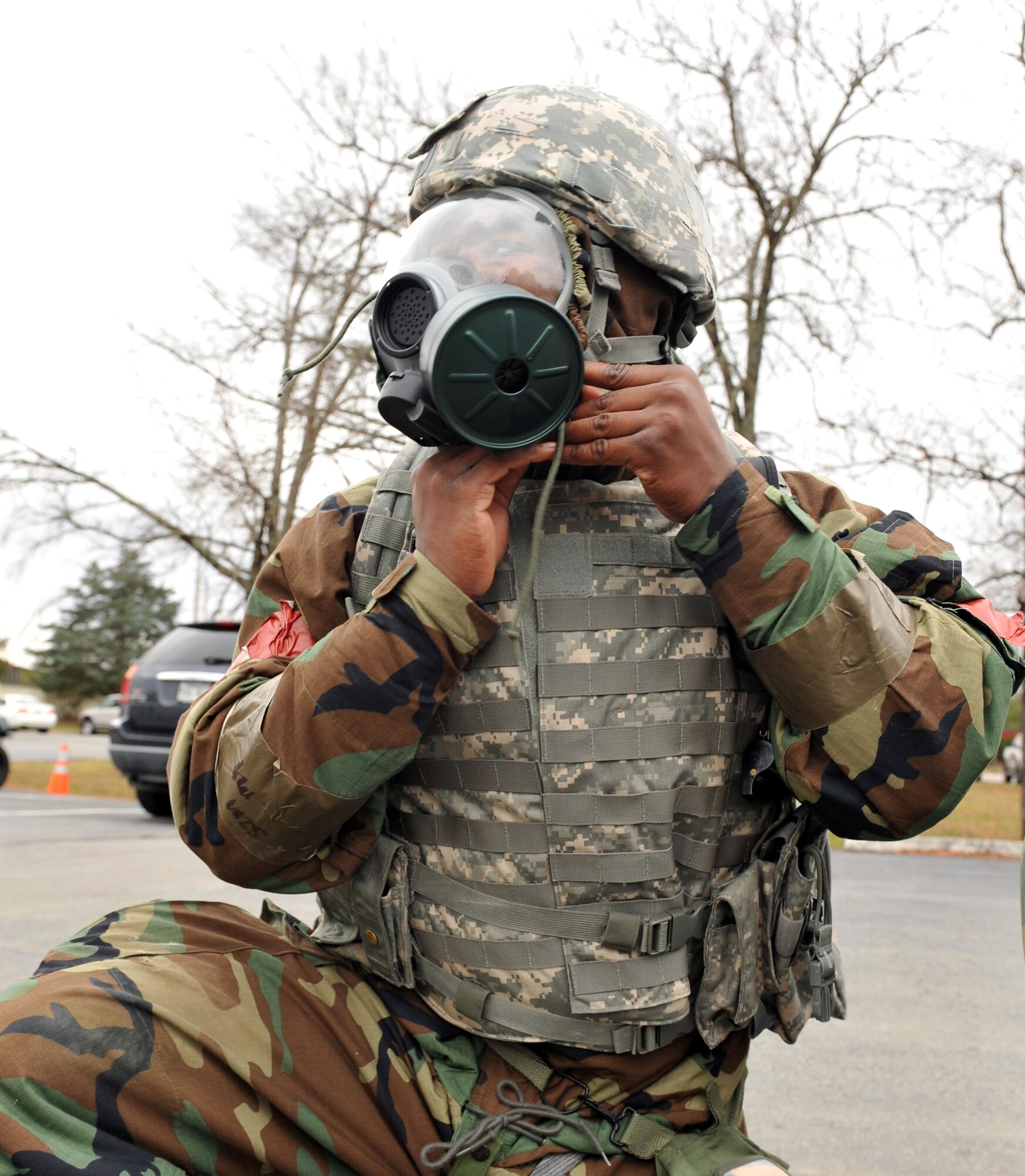 Airman 1st Class Domenique Watkins-Wise, 19th Security Force flight line patrolman, tightens the straps on his gas mask after an attack warning signal was announced during a base exercise Nov. 18. (U.S. Air Force photo by Staff Sgt. Chris Willis)