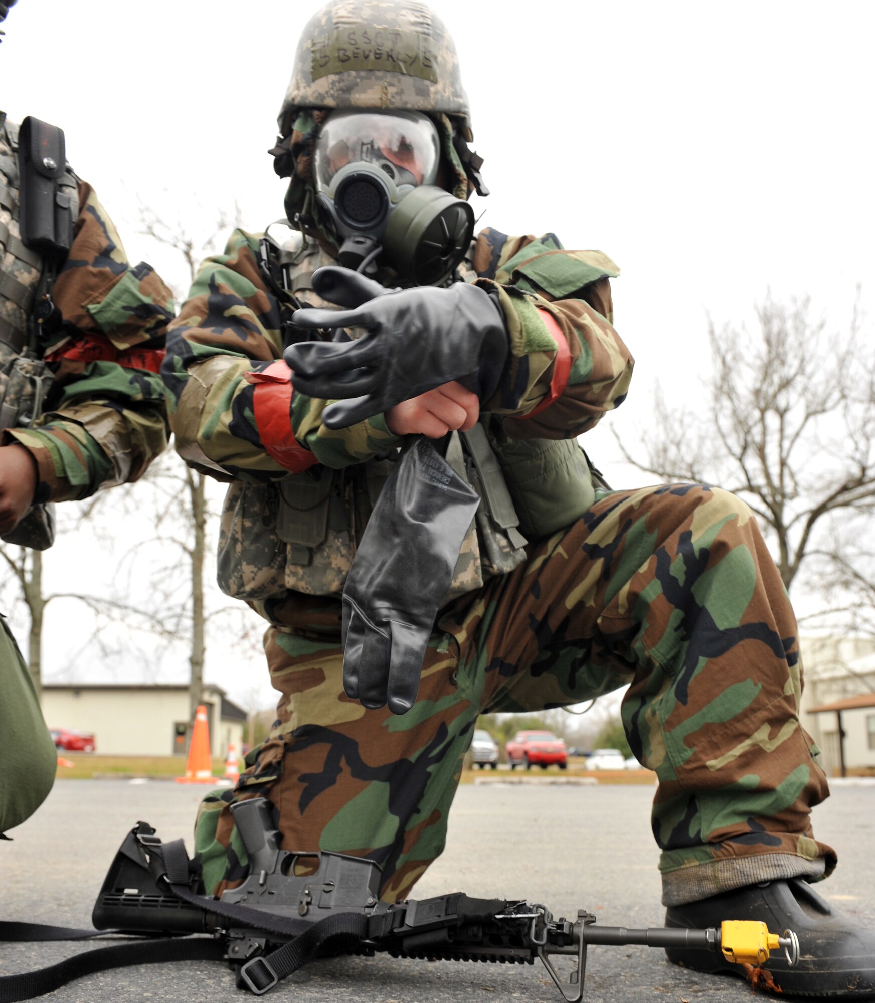 Staff Sgt Christopher Beverly, 19th Security Forces Squadron installation patrolman, dons on his individual protective gear after an announced simulated attack had occurred during a base exercise Nov. 18. (U.S. Air Force photo by Staff Sgt. Chris Willis)