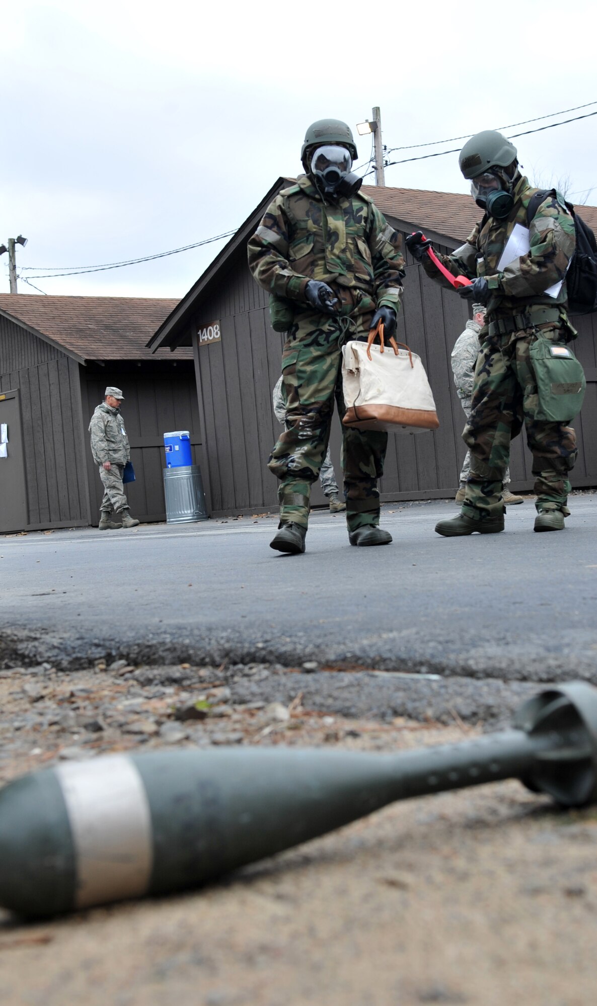Airman Brian Hargett and Airman 1st Class Brandon Shoop, 19th Force Support Squadron dining facility shift workers, identify and call in an unexploded ordinance during a base exercise Nov. 18. (U.S. Air Force photo by Staff Sgt. Chris Willis)