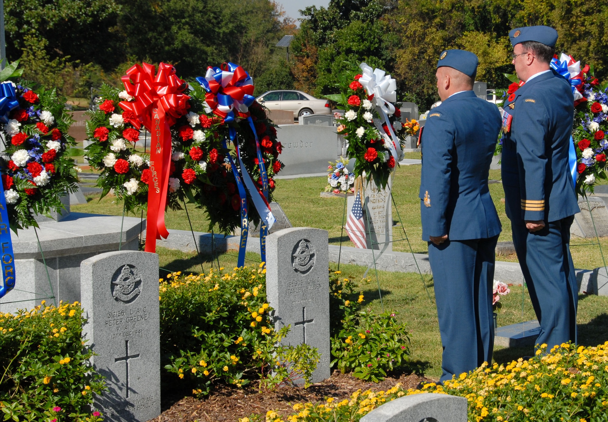 Maxwell and Gunter officials joined international officers Sunday at Montgomery’s Oakwood Cemetery for the annual Service of Remembrance for British and French war dead. Eighty members of the Royal Air Force along with 20 French airmen are buried in Oakwood Cemetery. They died in training accidents while undergoing flight training at Maxwell and Gunter during World War II. Chief Warrant Officer Gabriel Chartier (left) and Lt. Col. Michael Raftier, both of the Canadian Air Force, salute the fallen. (U.S. Air Force photo/Roger Curry)

