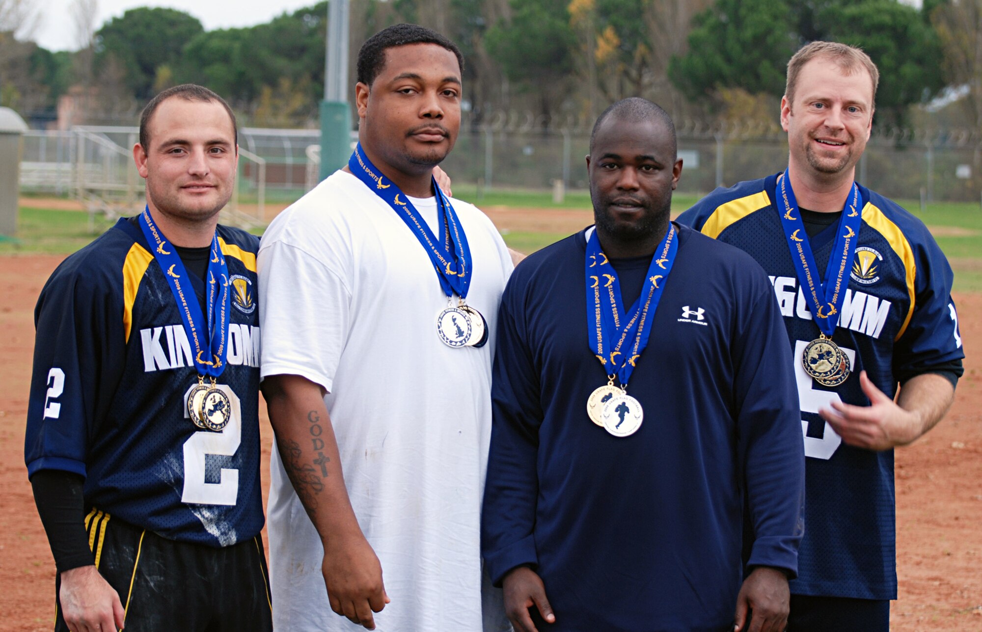 CAMP DARBY, Italy -- Staff Sgt. Cordney Morehead, 52nd Aerospace Medicine Squadron and team coach (second from left), stands with coaches from other teams during the first U.S. Air Forces in Europe flag football championship in Camp Darby, Italy, held Nov. 12-16. The Spangdahlem Air Base team tied for the best record, but came in third place overall. (U.S. Army photo/Joyce Costello)