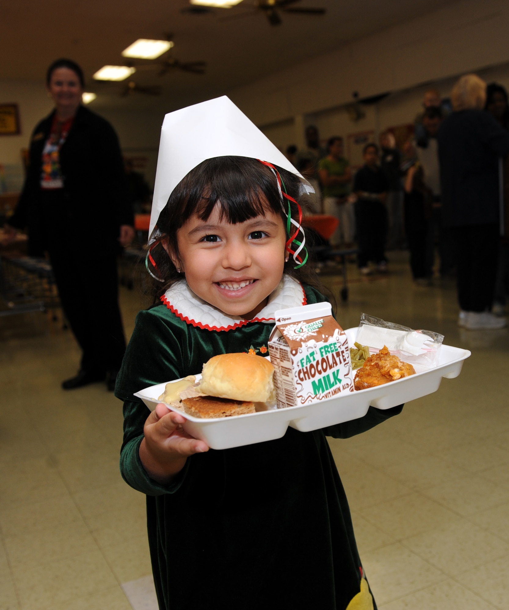 Andrea Galloway, 4, daughter of Tech. Sgt. Randall Galloway, 19th Logistics Readiness Squadron, carries an early Thanksgiving lunch Nov. 19 at Arnold Drive Elementary to eat with her family. The school had a Thanksgiving lunch for students and their families to enjoy the holiday. (U.S. Air Force photo by Senior Airman Ethan Morgan)
