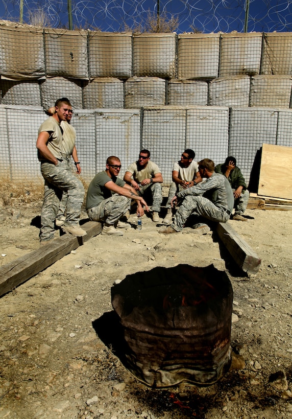 U.S. Army soldiers take a break from fortifying the latrine area with sandbags on Combat Outpost Munoz, Paktika province, Afghanistan, Nov. 13, 2009. The soldiers are assigned to Company B, 3rd Battalion, 509th Infantry.