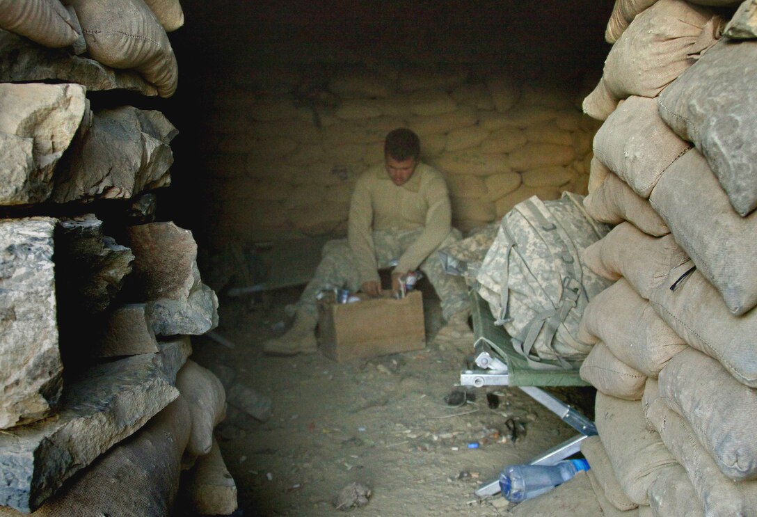 U.S. Army Pfc. Joshua Morgan searches for something to eat while assigned to a small observation post near Combat Outpost Munoz, Paktika province, Afghanistan, Nov. 15, 2009. Morgan is assigned to Company B, 3rd Battalion, 509th Infantry.