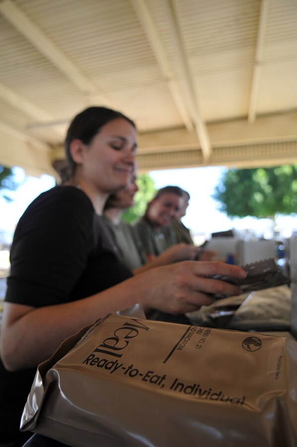 Jen Wood, Marine Attack Squadron 311 spouse, enjoys a Meal, Ready-to-Eat for lunch with other Marine family members at the Marine Corps Air Station in Yuma, Ariz., during the squadron’s Jane Wayne day Nov. 20, 2009. Jane Wayne days allow family members to experience the cornerstones of Marine training and conditioning, such as physical training and weapons handling. The family members got a taste of the Marine Corps Martial Arts Program, weapons training, obstacle course, combat fitness test and the station’s flight simulator during the squadron’s Jane Wayne day.
