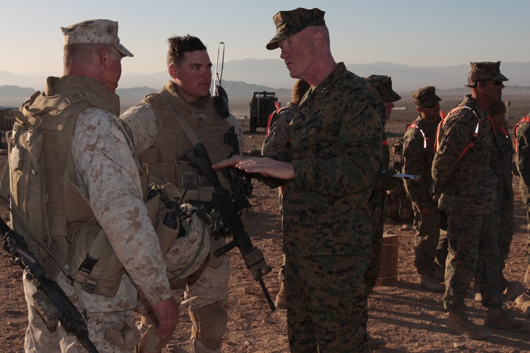 MARINE CORPS AIR GROUND COMBAT CENTER TWENTYNINE PALMS, Calif. - Maj. Gen. Richard P. Mills (right), the 1st Marine Division commanding general, discusses Company L, 3rd Battalion, 7th Marine Regiment's upcoming 'attack' on the Combat Center's Range 400 with Lt. Col. Clay C. Tipton (left), the battalion's commanding officer, and Staff Sgt. Joel Reilly, the platoon sergeant of Weapon's Platoon, Co. L. Mills observed the company's training to show his support of the battalion's participation in the Enhanced Mojave Viper pre-deployment training.