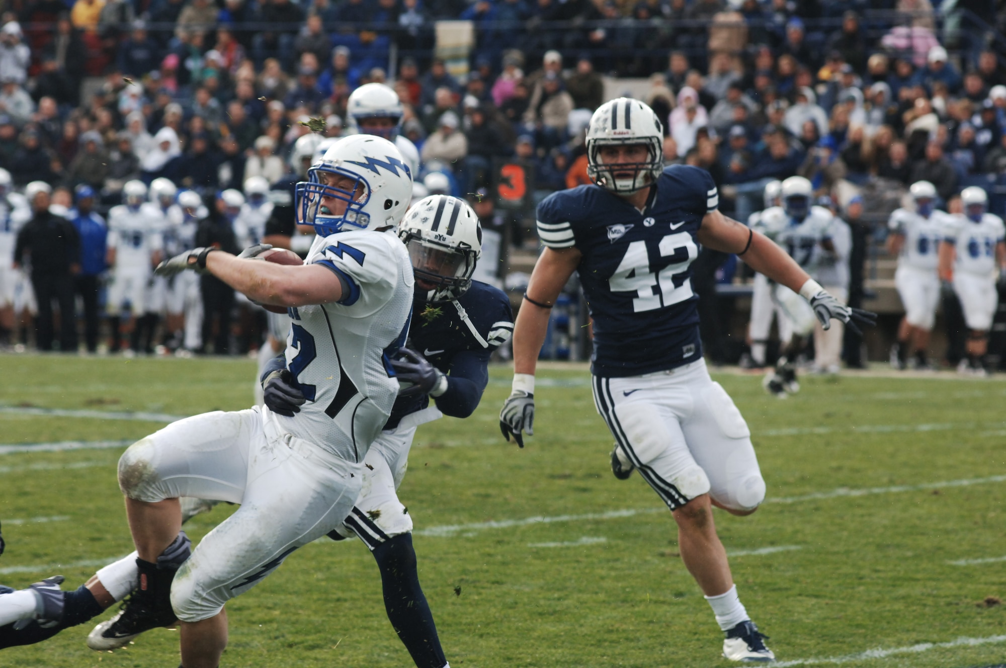 Cougars defenders tackle Falcons running back Jared Tew at the end of a 29-yard run during the Air Force-BYU game at LaVell Edwards Stadium in Provo, Utah, Nov. 21, 2009. Tew led the Falcons running game with 19 carries for 82 yards. Air Force had 212 rushing yards on the day and 300 total yards in the 38-21 loss to BYU. (U.S. Air Force photo/Staff Sgt. Don Branum)