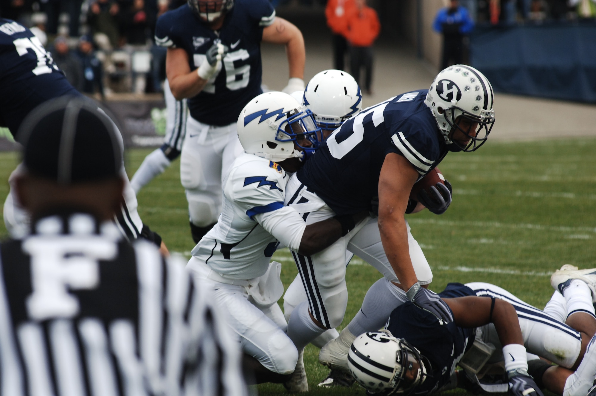 Falcon defenders bring down Cougars running back Harvey Unga during the Air Force-BYU game at LaVell Edwards Stadium in Provo, Utah, Nov. 21, 2009. Unga, a junior and native of Provo, had 11 carries for 67 yards in BYU's 38-21 victory. (U.S. Air Force photo/Staff Sgt. Don Branum)