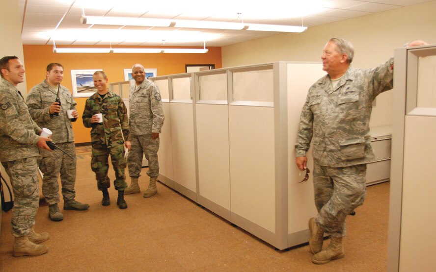 Airmen from the 752nd Aircraft Maintenance Squadron preview what will be crew chief office bays. Some Airmen claimed desks while others joked about the possibility of getting lost in the new building. The large, carefully designed building will be a big change for squadron after getting by with minimal space in the old firehouse for the past four years. (U.S. Air Force photo by Megan Just)