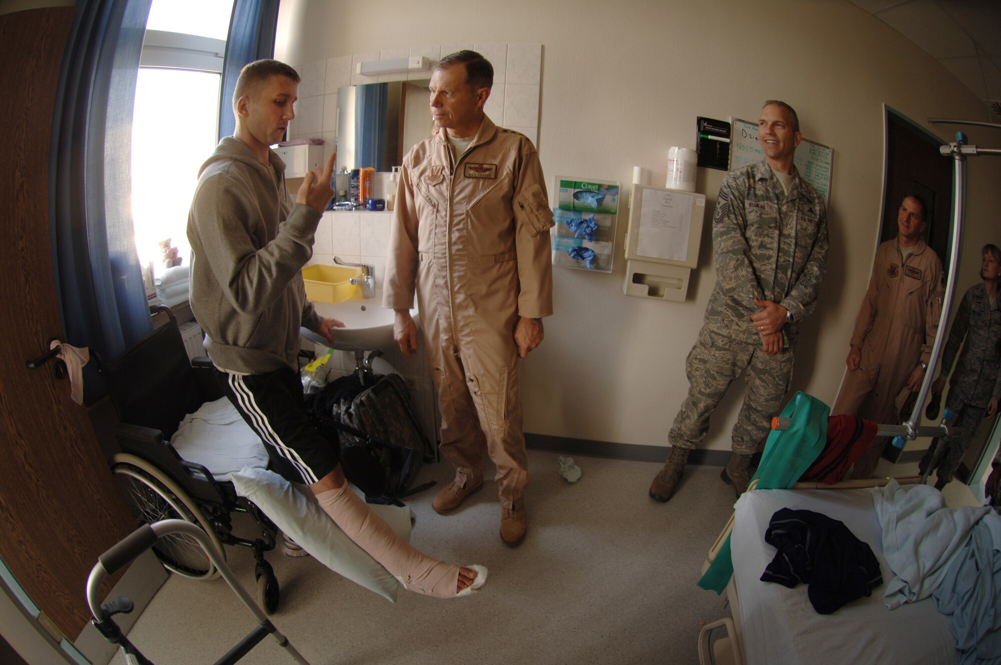 Air Combat Command's senior officer and enlisted leader, Gen. William M. Fraser III, commander, and Chief Master Sgt. Marty Klukas, command chief (right), visit Landstuhl Regional Medical Center, Nov. 20, where they met hospital staff and wounded U.S. and coalition servicemembers like Polish Corporal Waldemar Amrozi, who explained how injuries he sustained in Afghanistan nearly cost the loss of his right leg. Since 2004, the hospital has treated more than 58,000 wounded U.S. and coalition servicemembers and civilians injured in Iraq and Afghanistan. (Photo: Master Sgt. Scott Wagers/Defense Media Activity Ramstein)