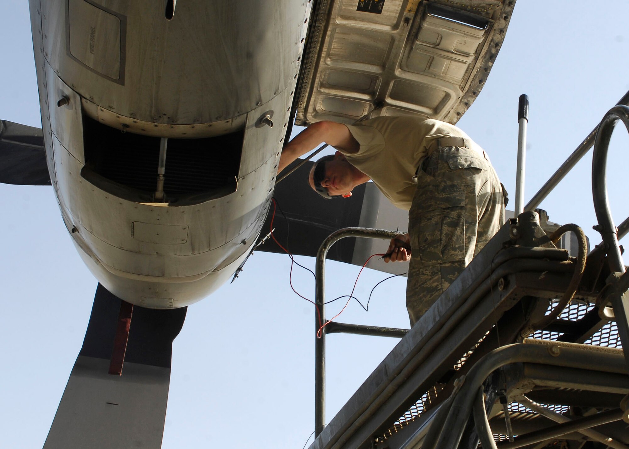 BAGRAM AIRFIELD, Afghanistan -- Senior Airman Gregory Hovore, crew chief from the 455th Expeditionary Aircraft Maintenance Squadron, inspects the propeller of the C-130 Hercules to make sure the aircraft has enough power for its mission Nov. 21, 2009.  With the ability to take off and land on dirt or rough landing strips, the Hercules is used to move troops and equipment into hostile areas.  Airman Hovore, a Reno, Nev. native, is deployed from the Nevada Air National Guard's 152nd Aircraft Maintenance Squadron.  (U.S. Air Force photo/Senior Airman Felicia Juenke)