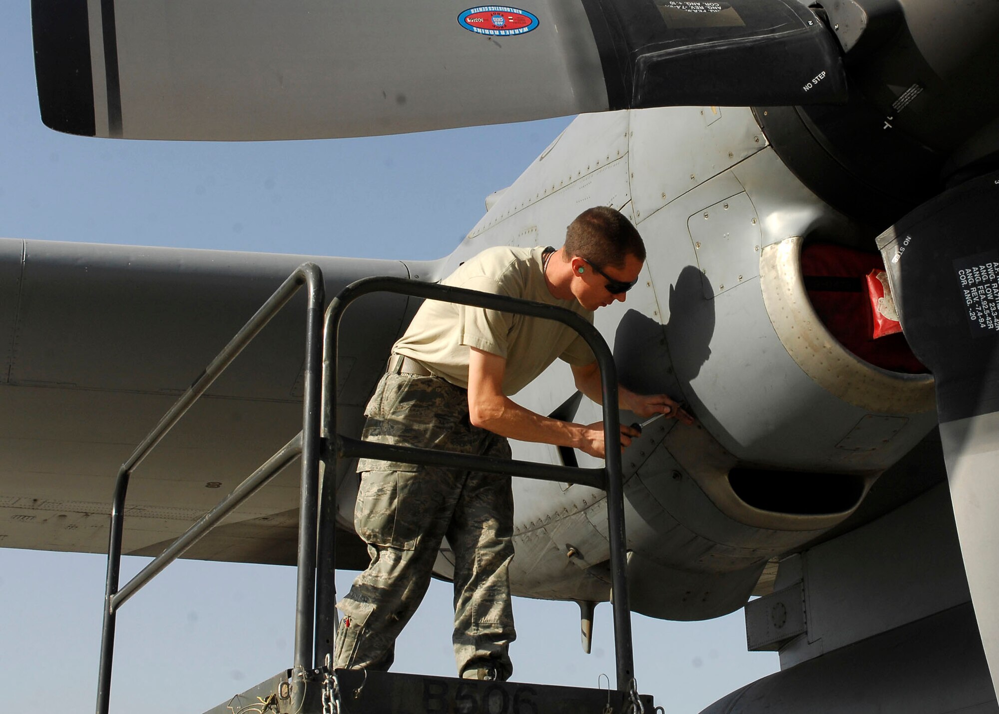 BAGRAM AIRFIELD, Afghanistan -- Senior Airman Gregory Hovore, crew chief from the 455th Expeditionary Aircraft Maintenance Squadron, removes a panel to inspect the propeller of the C-130 Hercules Nov. 21, 2009.  With the ability to take off and land on dirt or rough landing strips, the Hercules is used to move troops and equipment into hostile areas.  Airman Hovore, a Reno, Nev. native, is deployed from the Nevada Air National Guard?s 152nd Aircraft Maintenance Squadron.  (U.S. Air Force photo/Senior Airman Felicia Juenke)