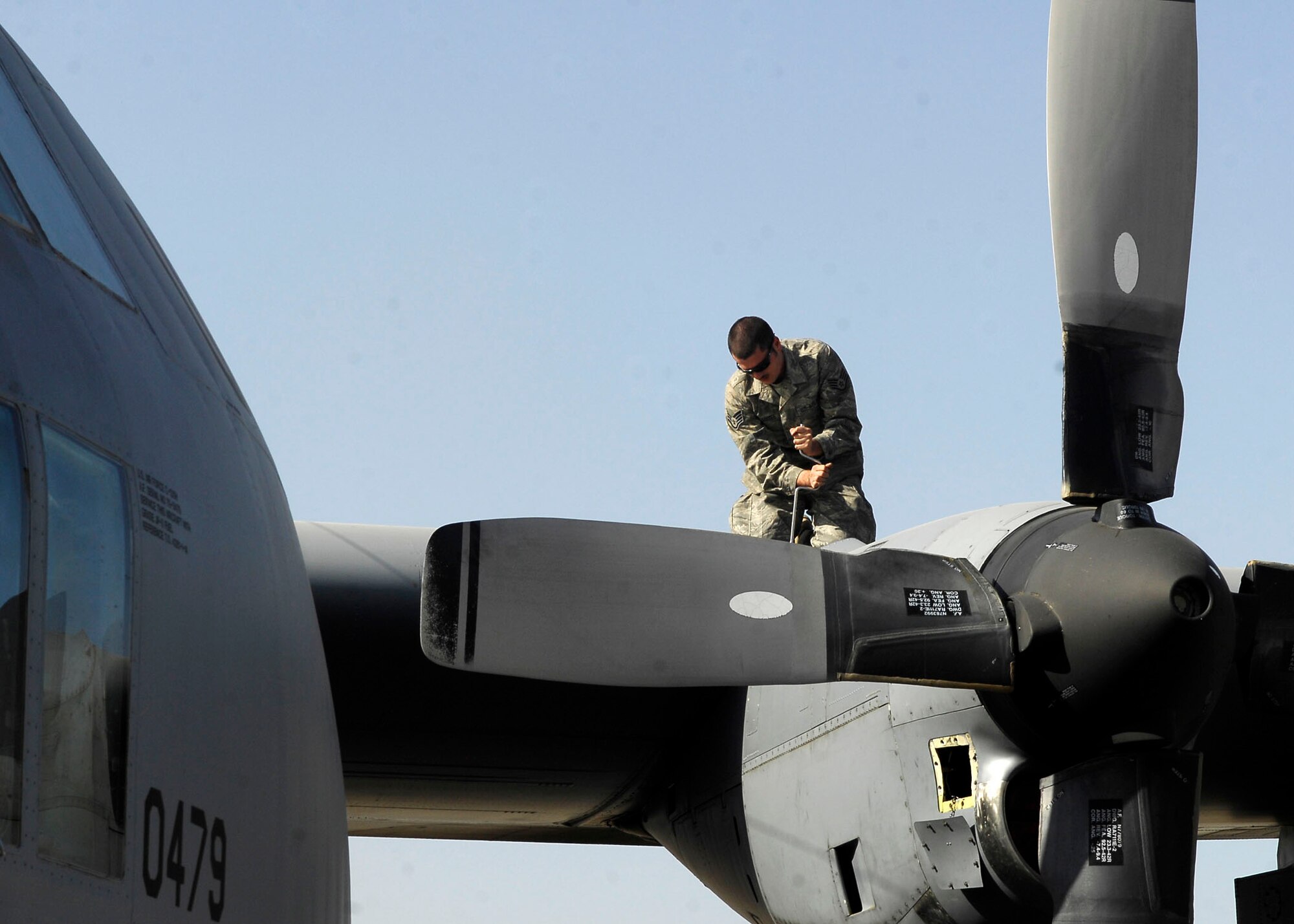 BAGRAM AIRFIELD, Afghanistan -- Staff Sgt. John Magee, crew chief from the 455th Expeditionary Aircraft Maintenance Squadron, removes a panel to inspect the wing of the C-130 Hercules Nov. 21, 2009.  With the ability to take off and land on dirt or rough landing strips, the Hercules is used to move troops and equipment into hostile areas.  Sergeant Magee, a Reno, Nev. native, is deployed from the Nevada Air National Guard's 152nd Aircraft Maintenance Squadron.  (U.S. Air Force photo/Senior Airman Felicia Juenke)