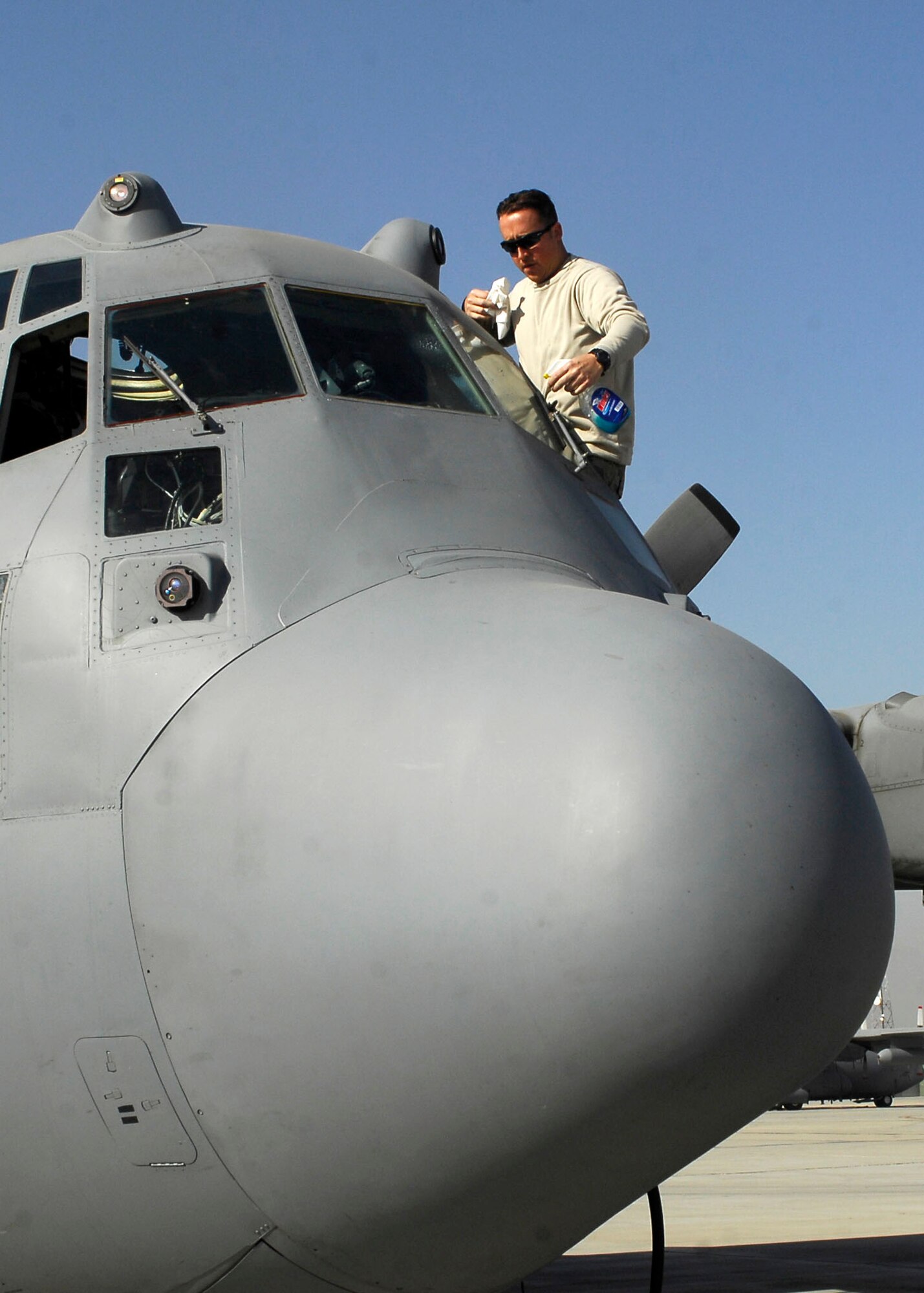 BAGRAM AIRFIELD, Afghanistan -- Staff Sgt. Ken Roberts, a crew chief from the 455th Expeditionary Aircraft Maintenance Squadron, cleans the windows of a C-130 Hercules Nov. 21, 2009.  During preflight inspections the crew makes sure that all safety precautions are taken to include cleaning the windows of any debris.  Sergeant Roberts is deployed from Pope Air Force Base, N.C., and hails from Oneonta, N.Y.  (U.S. Air Force photo/Senior Airman Felicia Juenke)