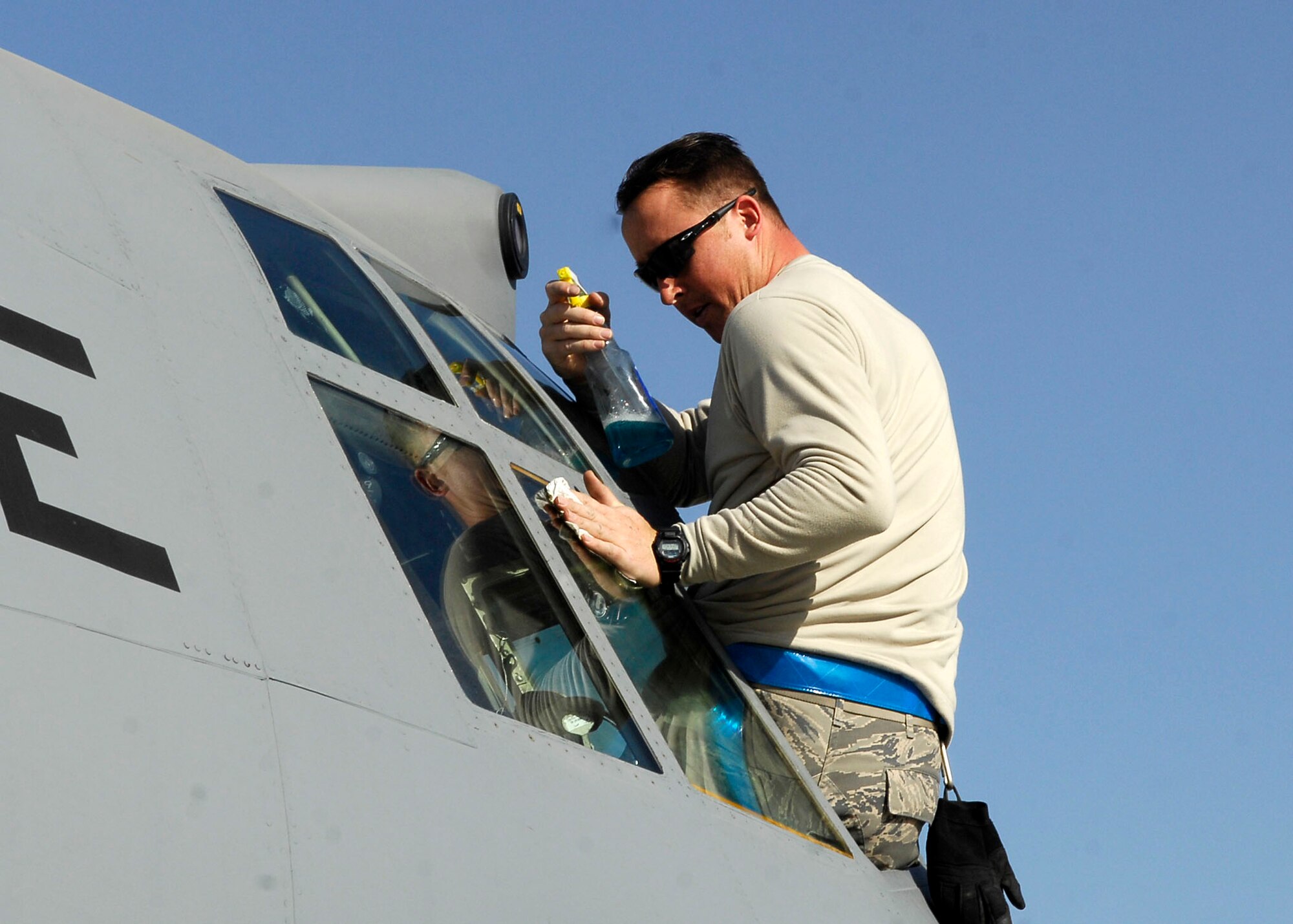 BAGRAM AIRFIELD, Afghanistan -- Staff Sgt. Ken Roberts, a crew chief from the 455th Expeditionary Aircraft Maintenance Squadron, cleans the windows of a C-130 Hercules Nov. 21, 2009.  During preflight inspections the crew makes sure that all safety precautions are taken to include cleaning the windows of any debris.  Sergeant Roberts is deployed from Pope Air Force Base, N.C., and hails from Oneonta, N.Y.  (U.S. Air Force photo/Senior Airman Felicia Juenke)