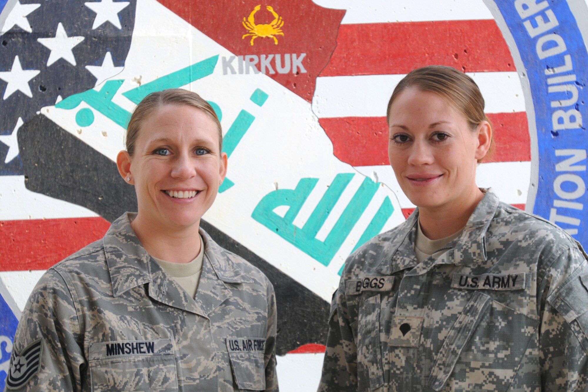 KIRKUK REGIONAL AIR BASE, Iraq - Sisters in arms, Tech. Sgt. Miranda Minshew, 506th Expeditionary Medical Squadron, and Spc. Julie Boggs, 263rd Quartermaster Company, recently reunited at Kirkuk Air Base after not seeing each other for more than three years.  Sergeant Minshew is deployed from the 377th Aerospace Medical Squadron, Kirtland Air Force Base, N.M. and Specialist Boggs is deployed from the 1013th Quartermaster Company, North Platte, Neb.  (U.S. Air Force photo/Staff Sgt. Joshua Breckon)