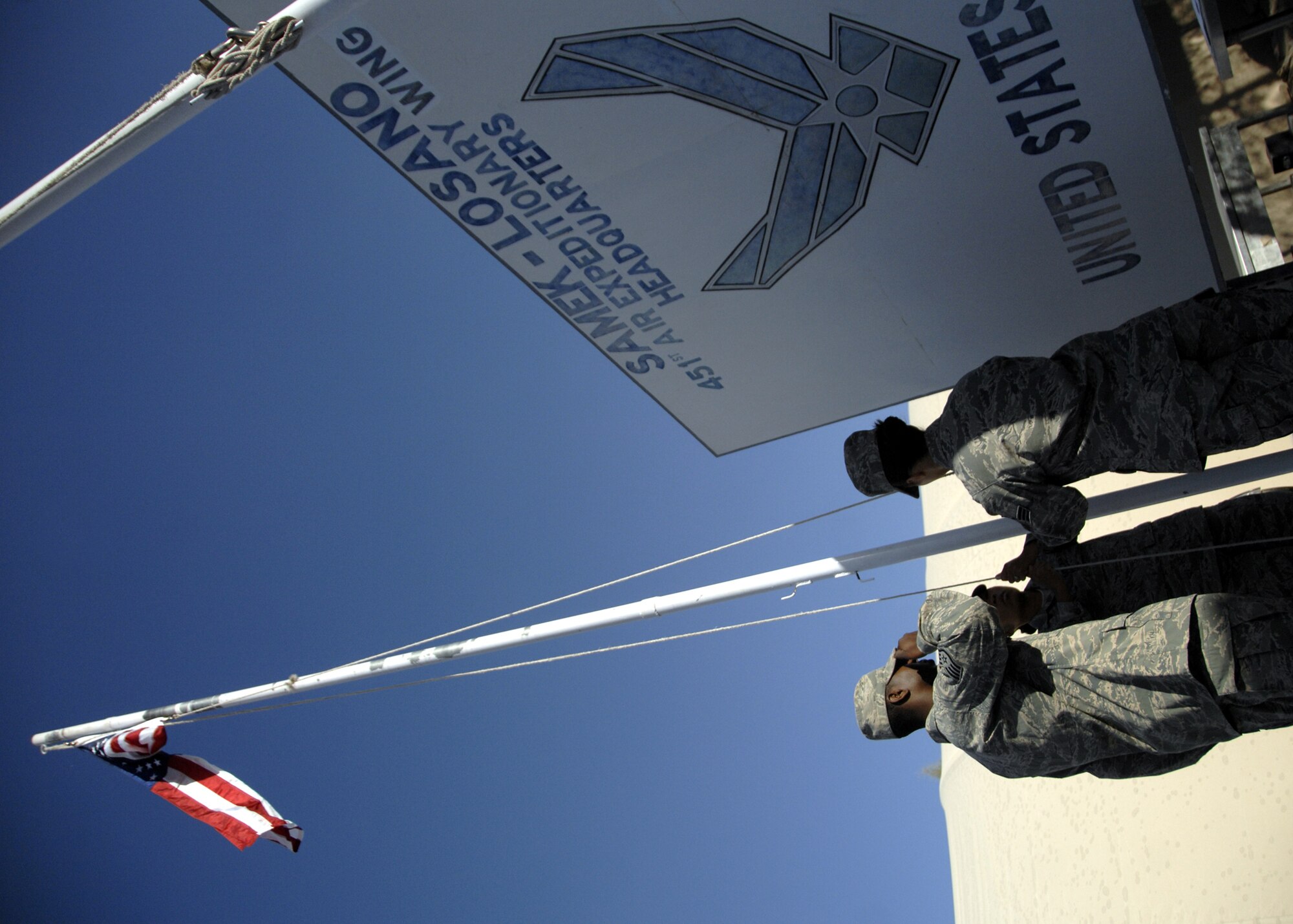Members from the 451st Air Expeditionary Wing Honor Guard raise the American flag to honor veterans during Veteran's Day here, Nov. 11, 2009. More than one-hundred Airmen assembled at Camp Samek to honor war veterans. Veteran's Day was officially approved by Congress on June 4, 1926. (U.S. Air Force photo/Senior Airman Timothy Taylor)