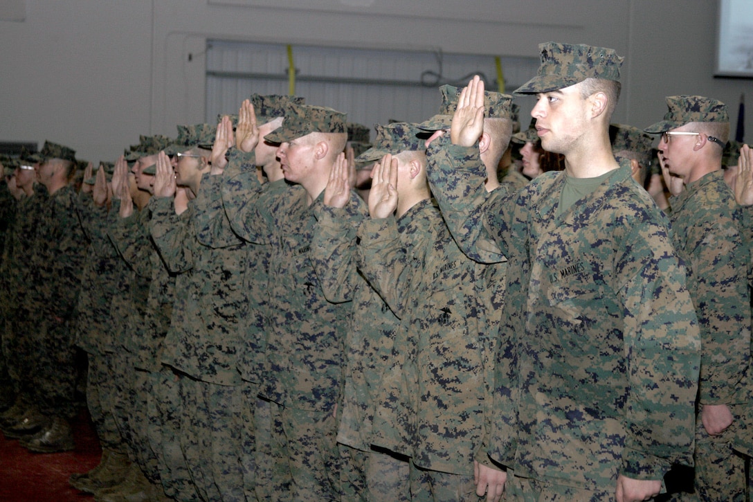 Recruits from Echo Company, 2nd Recruit Training Battalion, raise their right hands and recite the enlistment oath during the Eagle, Globe and Anchor ceremony held Jan. 19.