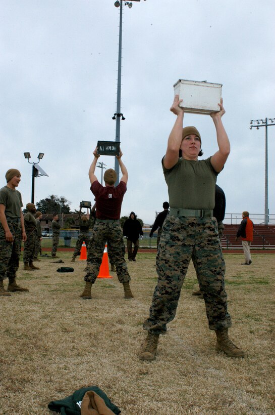 Sgt. Jessica Kirkus, the Recruit Administration Center noncommissioned officer-in-charge, does repetitions with a 30 pound ammunition can during a Combat Fitness Test trial run.