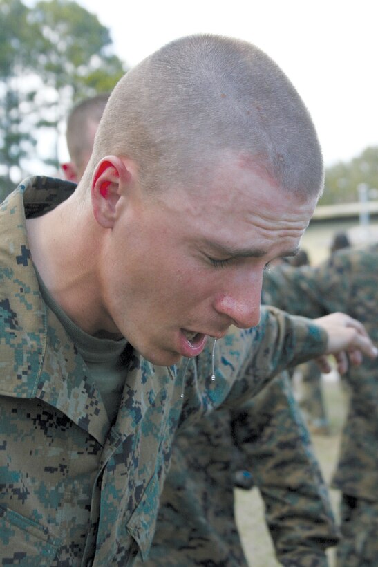 A recruit from Hotel Company, 2nd Recruit Training Battalion, recovers from the gas chamber on March 3. Recruits must complete the gas chamber and rappel tower before transitioning to second phase.::n::