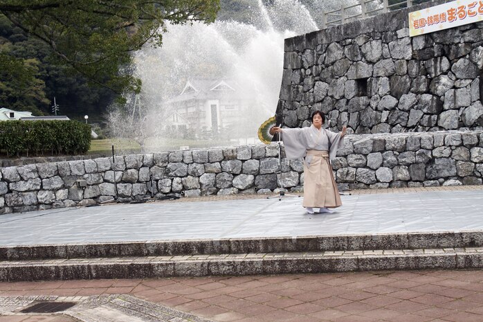 A woman performs nihon buyou, a form of traditional Japanese dancing, before an audience assembled at Kikko Park in Iwakuni city during the Kintaikyo Momiji (Kintai Bridge Maple Leaf Festival) Sunday. Various forms of Japanese traditional music and dance forms were showcased throughout the park during the festival.