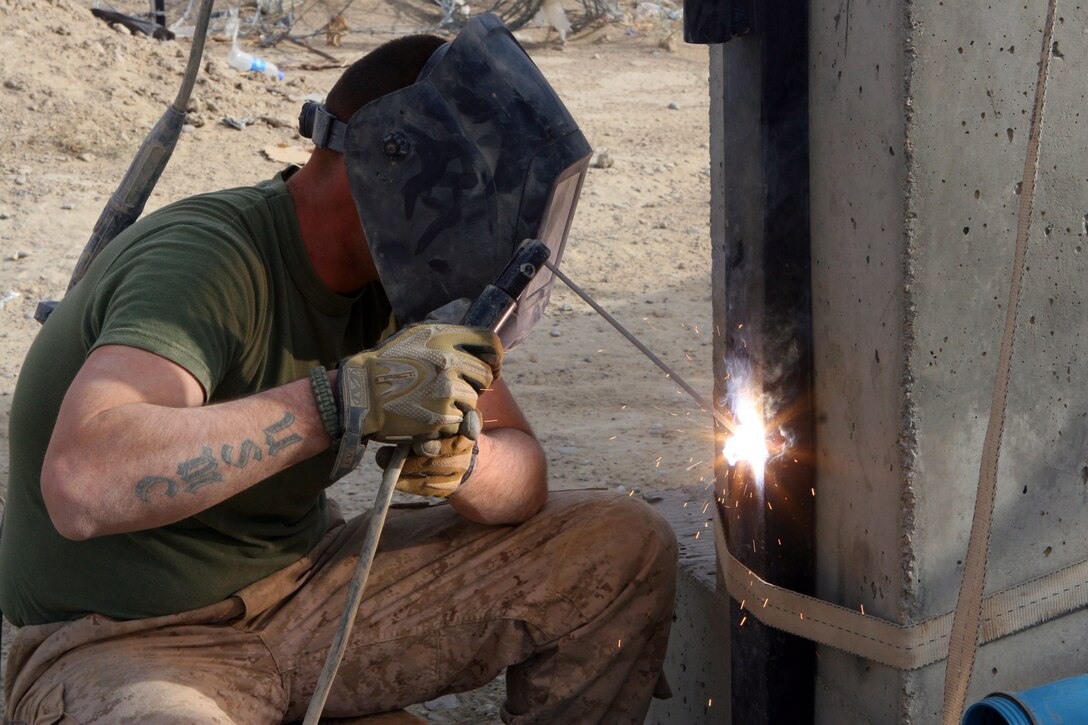Cpl. Malcolm S. Leachman, a basic metal worker for Alpha Company, 2nd Combat Engineer Battalion, is strengthening the an entry gate at Forward Operating Base Delhi, Nov. 22. This work was a part of a re-supply mission to forward operating bases. 2nd Battalion, 2nd Marine Regiment, occupies FOB Delhi conducting counter insurgency operations.