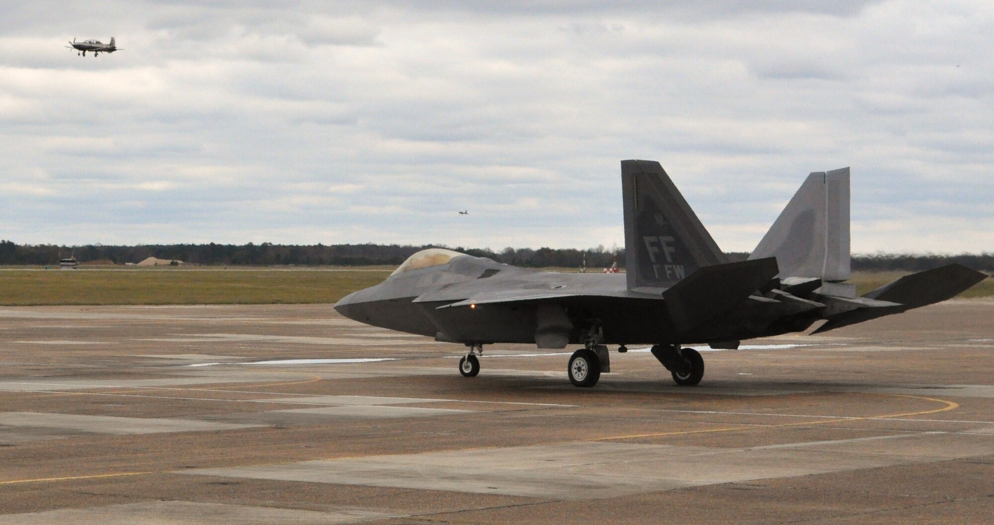 An F-22A Raptor from passed through Columbus AFB for fuel enroute to its home station of Langley AFB, Virginia on Nov. 17.  The sophisticated F-22 aero design, advanced flight controls, thrust vectoring, and high thrust-to-weight ratio provide the capability to outmaneuver all current and projected aircraft. (U.S. Air Force Photo/Sonic Johnson)