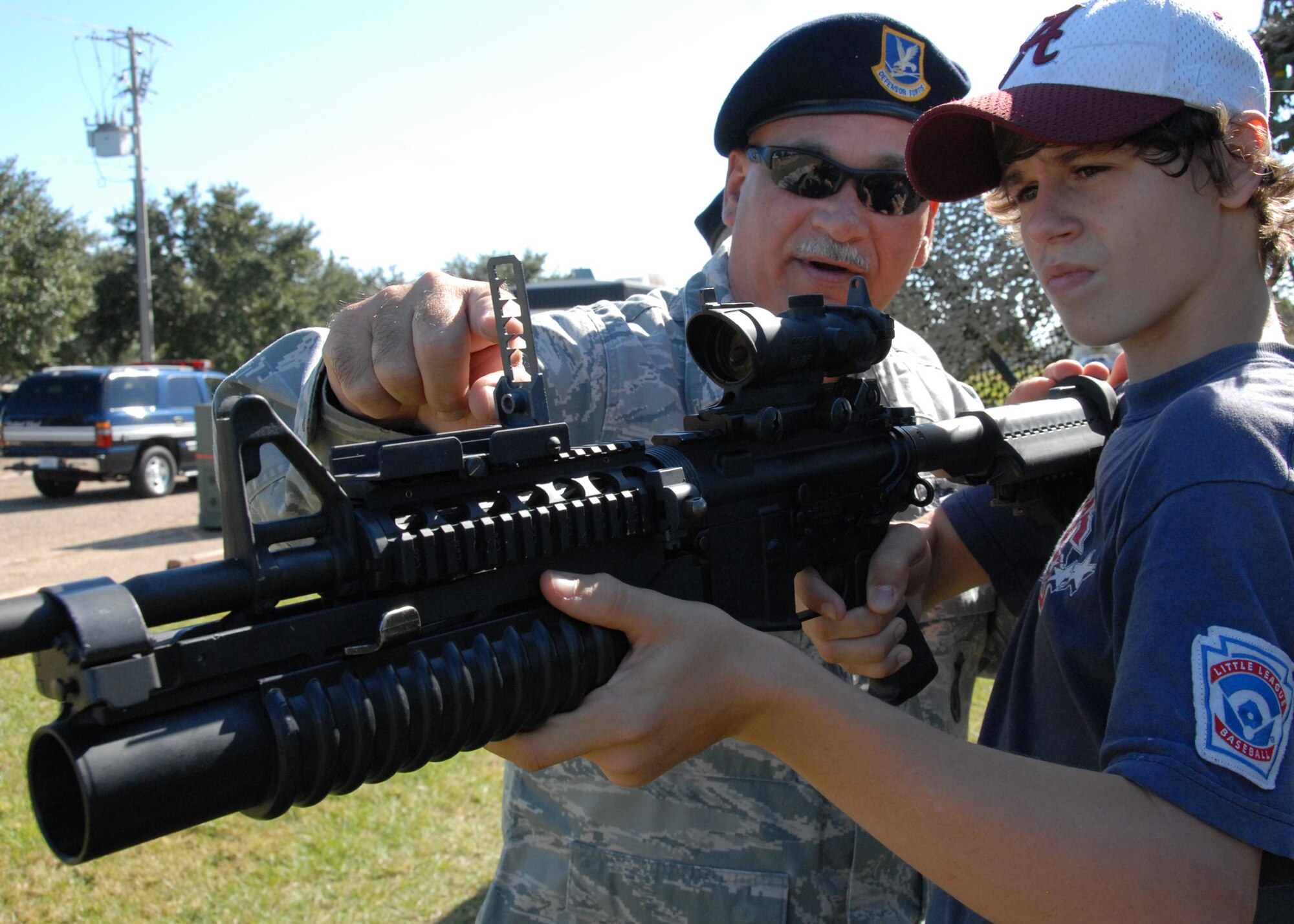 Tech Sgt. William Champion, 919th Security Forces explains the sighting mechanism on an M-4 rifle during Duke Field’s Family Day event Nov. 7.  The Family Day event brought reservists and their families together for food, games and music.  (Air Force photo/Staff Sgt. Samuel King Jr.)