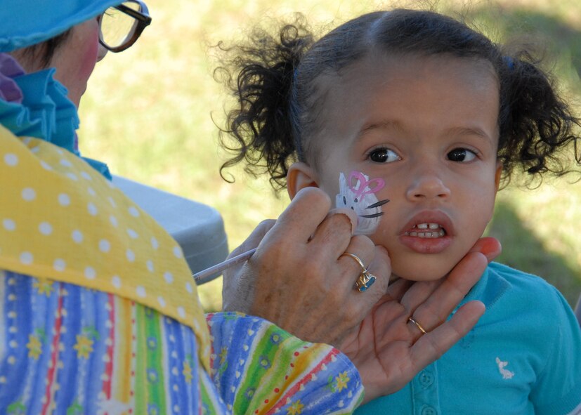 Taylor Davies, two-year –old daughter of Tech. Sgt. Latisha Davies, 919th Communications Squadron, gets a kitty painted on her face during Duke Field’s Family Day event Nov. 7.  The Family Day event brought reservists and their families together for food, games and music.  (Air Force photo/Staff Sgt. Samuel King Jr.)