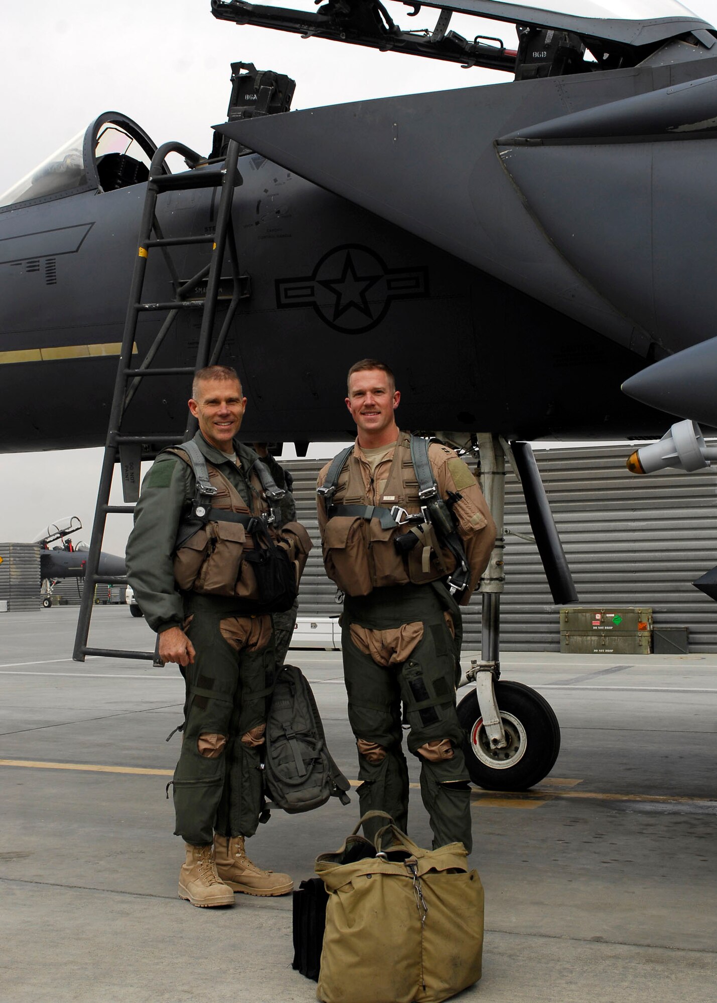BAGRAM AIRFIELD, Afghanistan -- Brig. Gen. Steven Kwast (left) and Capt. Ryan Bone (right) after their mission, Nov. 22, 2009.  Today marked a very important day for Capt. Bone, he reached the 1,000 flying hours.  "It feels good, reaching 1,000 hours in my first assignment," he said "not a lot of guys do that."  Capt. Bone is deployed from Seymour Johnson Air Force Base, N.C., and hails from Gainesville, Fla.  Gen. Kwast, the 455th Air Expeditionary Wing Commander, was previously stationed at Seymour Johnson AFB.  (U.S. Air Force photo/Senior Airman Felicia Juenke)