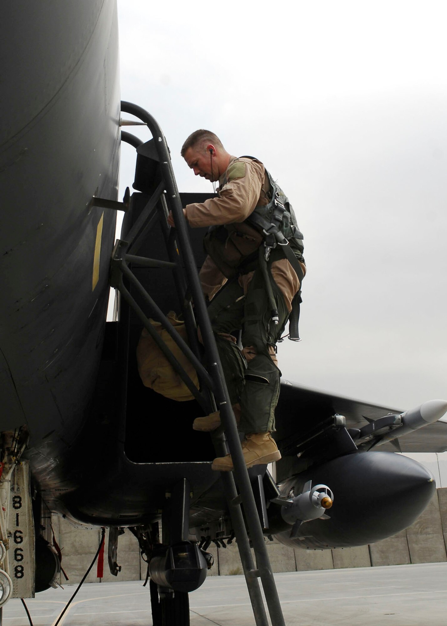 BAGRAM AIRFIELD, Afghanistan -- Capt. Ryan Bone, a weapons-systems officer from the 335th Expeditionary Fighter Squadron, climbs down the ladder of an F-15 Strike Eagle Nov. 22, 2009.   Today marked a very important day for Capt. Bone, he reached the 1,000 flying hours.  Capt. Bone is deployed from Seymour Johnson Air Force Base, N.C., and hails from Gainesville, Fla.  (U.S. Air Force photo/Senior Airman Felicia Juenke)