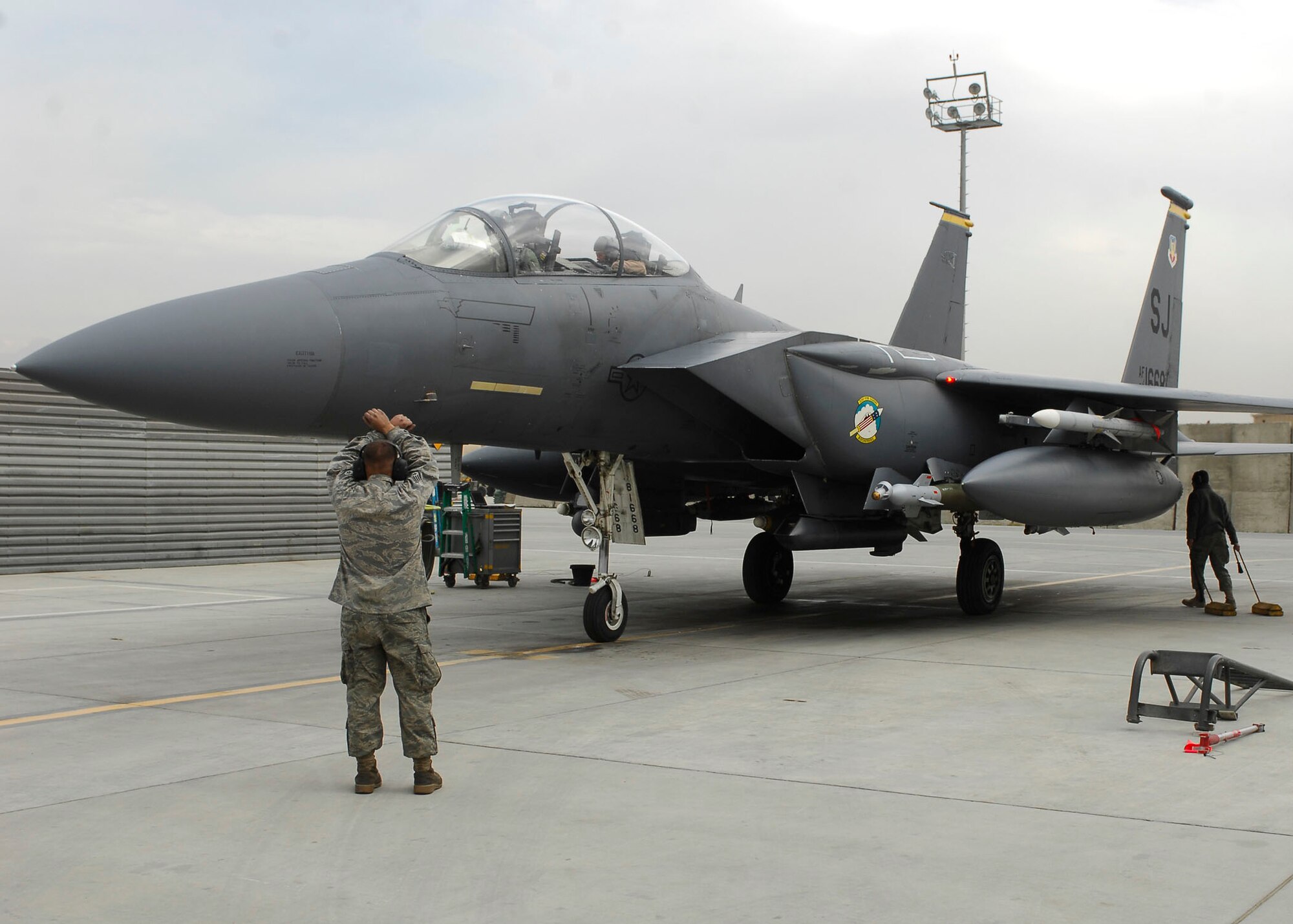 BAGRAM AIRFIELD, Afghanistan -- Brig. Gen. Steven Kwast (Pilot- front seat) and Capt. Ryan Bone (Weapons-Systems Officer- back seat) are signaled to stop while getting marshaled into a parking spot Nov. 22, 2009.  Today marked a very important day for Capt. Bone, he reached the 1,000 flying hours.  Capt. Bone is deployed from Seymour Johnson Air Force Base, N.C., and hails from Gainesville, Fla.  Gen. Kwast, the 455th Air Expeditionary Wing Commander, was previously stationed at Seymour Johnson AFB as the wing commander.  (U.S. Air Force photo/Senior Airman Felicia Juenke)
