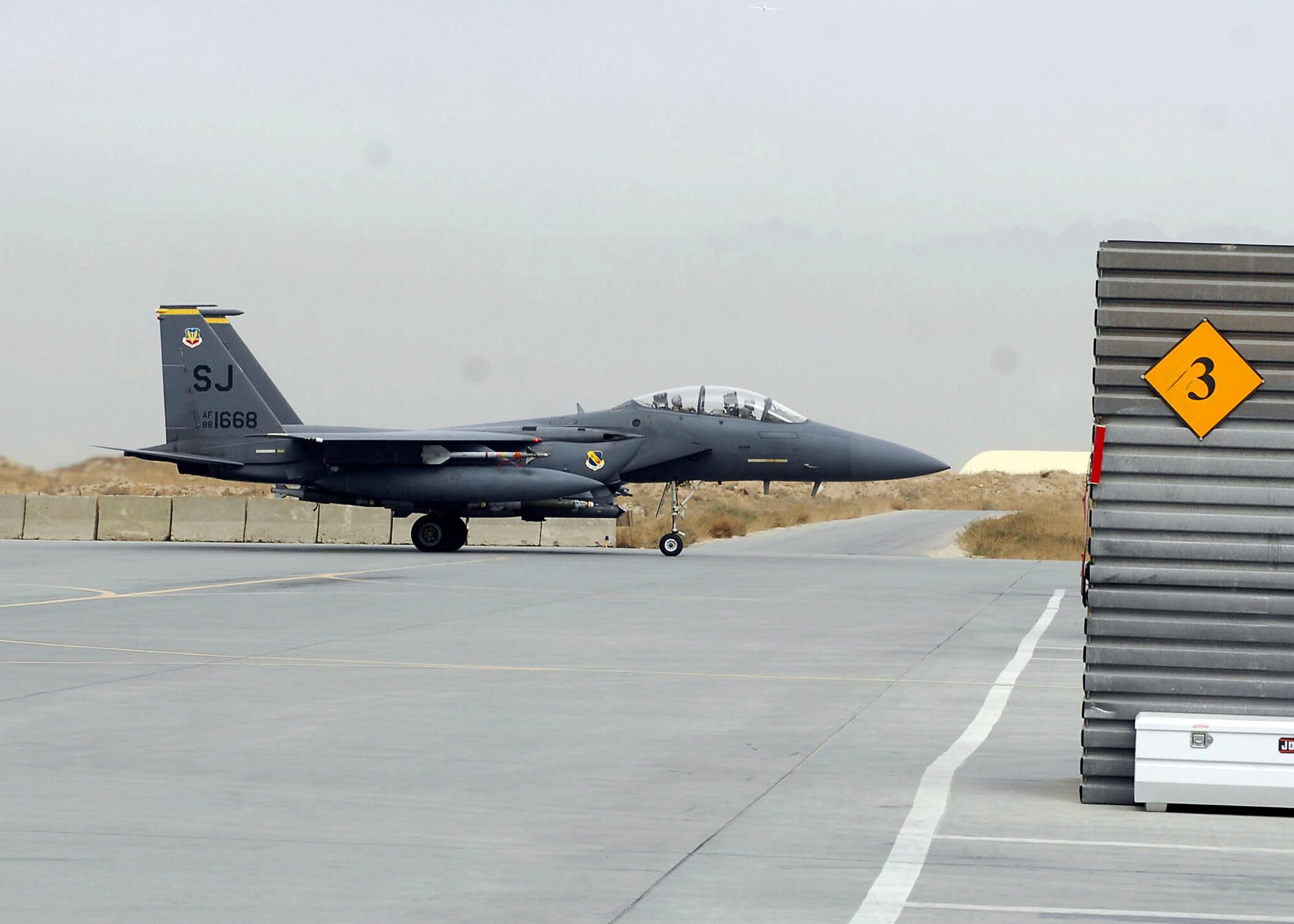 BAGRAM AIRFIELD, Afghanistan -- An F-15E Strike Eagle taxis to its proper parking spot after flying a mission in support of Operation Enduring Freedom, Nov. 22, 2009.  This F-15E is deployed from Seymour Johnson Air Force Base, N.C. Previous models of the F-15 are assigned air-to-air roles; the "E" model is a dual-role fighter.  It has the capability to fight its way to a target over long ranges, destroy enemy ground positions, and fight its way out.  (U.S. Air Force photo/Senior Airman Felicia Juenke)