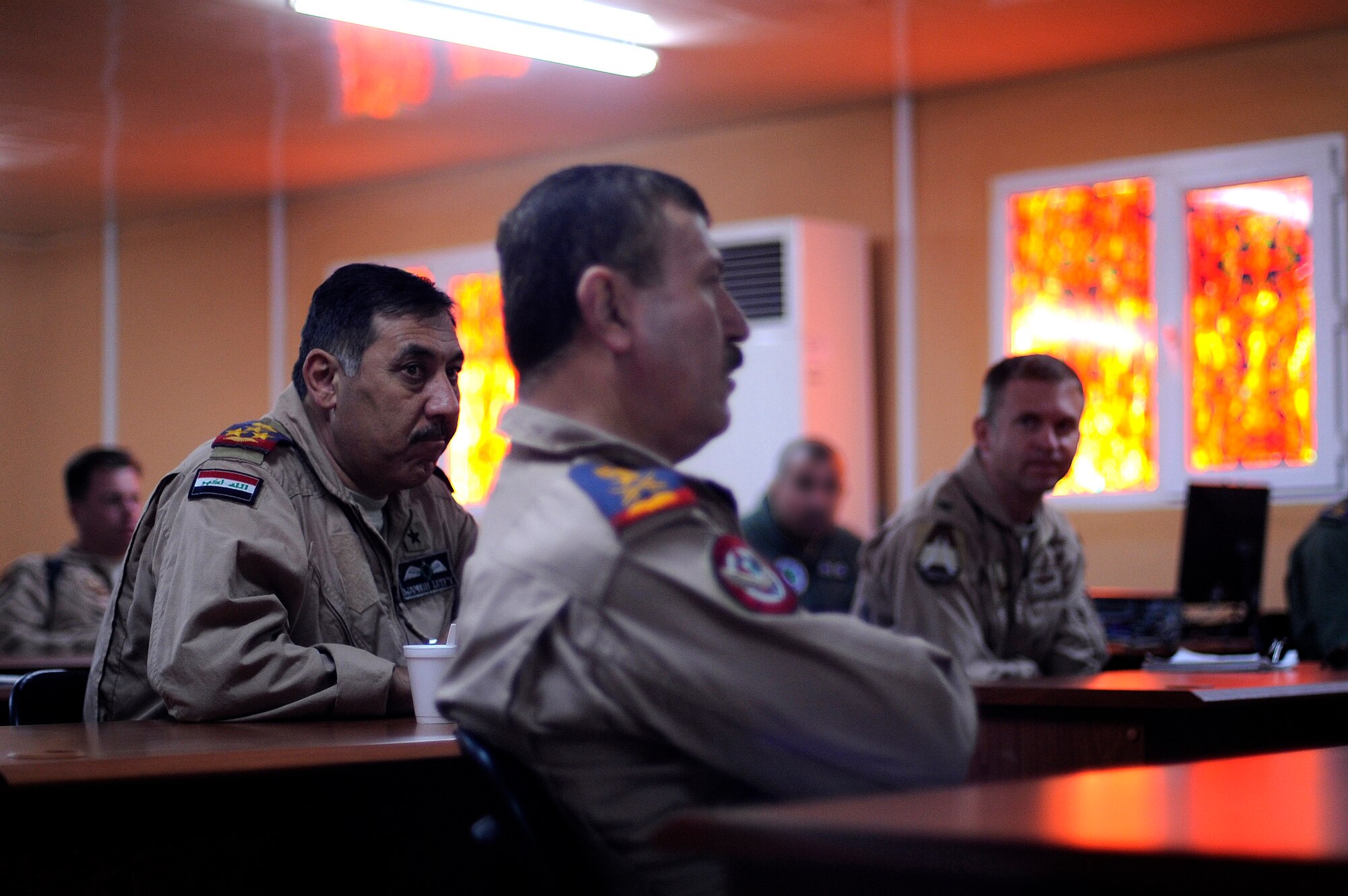 U.S. and Iraqi Air Force Airmen attend a pre-flight briefing at Kirkuk Air Base, Iraq, Oct. 21, 2009. The Iraqis are from Squadron 3, a unit that operates AC-208s. The U.S. Air Force Airmen assist as mentors. (U.S. Air Force photo/Staff Sgt. Michael B. Keller)
