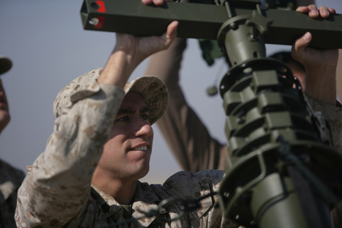 Sgt. Taylor A. Austin, from Brownsville, Tenn., helps set up a Wireless Point-to-Point Link device here Nov. 22. Marines set up the WPPL during communications training the 11th Marine Expeditionary Unit’s Joint Task Force Enabler held while ashore.