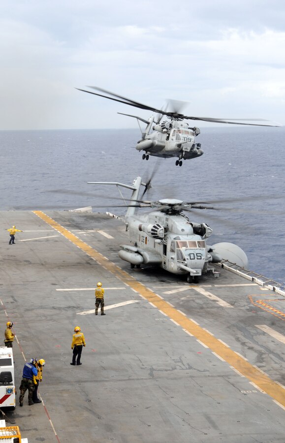 A CH-53E Super Stallion helicopter assigned to the "Iron Horses" of Marine Heavy Helicopter Squadron (HMH) 461, carrying Marines assigned to the first-ever Security Cooperation Marine Air-Ground Task Force (SCMAGTF) that will perform Theater Security Cooperation exercises with the Belize Defense Force, takes off on the flight deck of the multi-purpose assault ship USS Wasp (LHD 1) Monday. Wasp is currently deployed on Southern Partnership Station-Amphib with Destroyer Squadron 40 and embarked SCMAGTF. Southern Partnership Station is part of the Partnership of the Americas Maritime Strategy that focuses on building interoperability and cooperation in the region to meet common challenges. (U.S. Navy Photo by Mass Communication Specialist 3rd Class David Smart/Released)