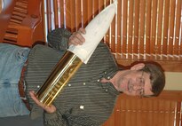 Mr. Shaud admires his specially inscribed 105mm canon shell casing, a retirement memento presented to him by fellow Duke Field maintainers.  (U.S. Air Force photo/Staff Sgt. Jon McCallum)