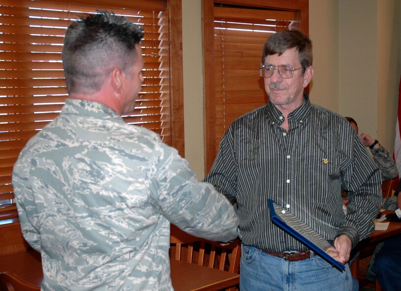 Mr. Shaud, right, receives his 30-year service certificate from Maj. Matt Heintzelman, 919th Maintenance Group executive officer.  (U.S. Air Force photo/Staff Sgt. Jon McCallum)